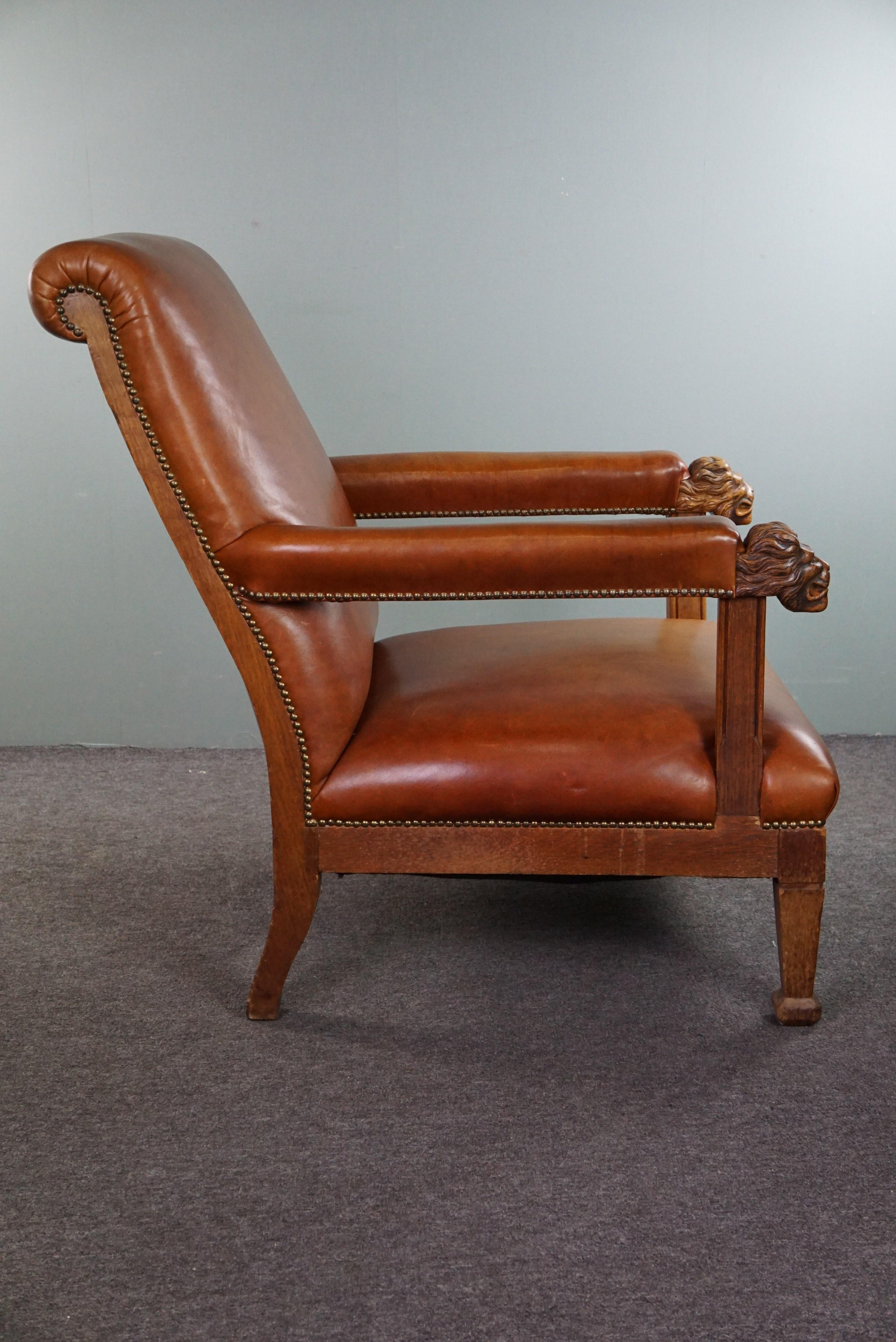 Dutch Armchair with lion heads reupholstered in cognac-colored cowhide For Sale