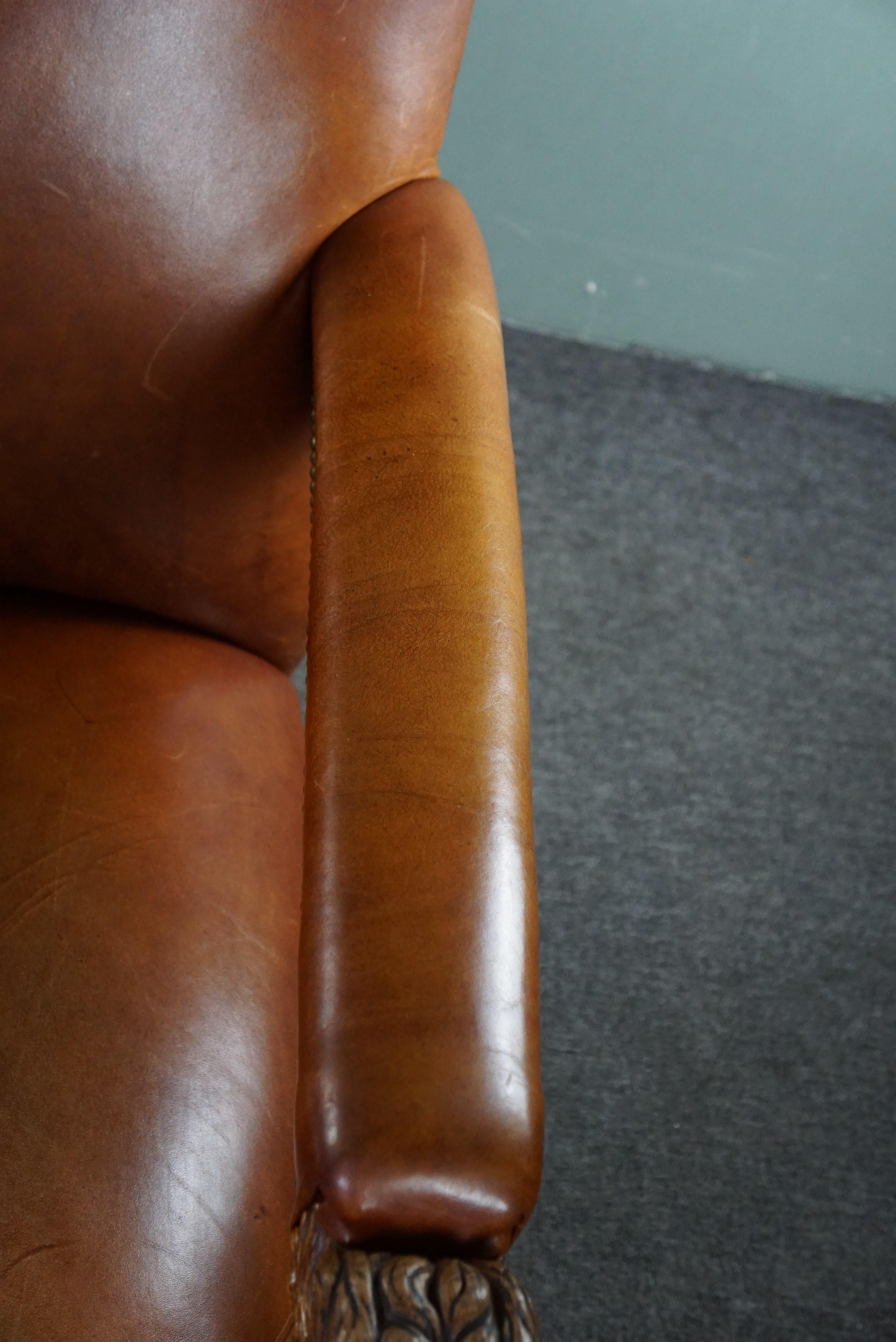 Armchair with lion heads reupholstered in cognac-colored cowhide For Sale 2