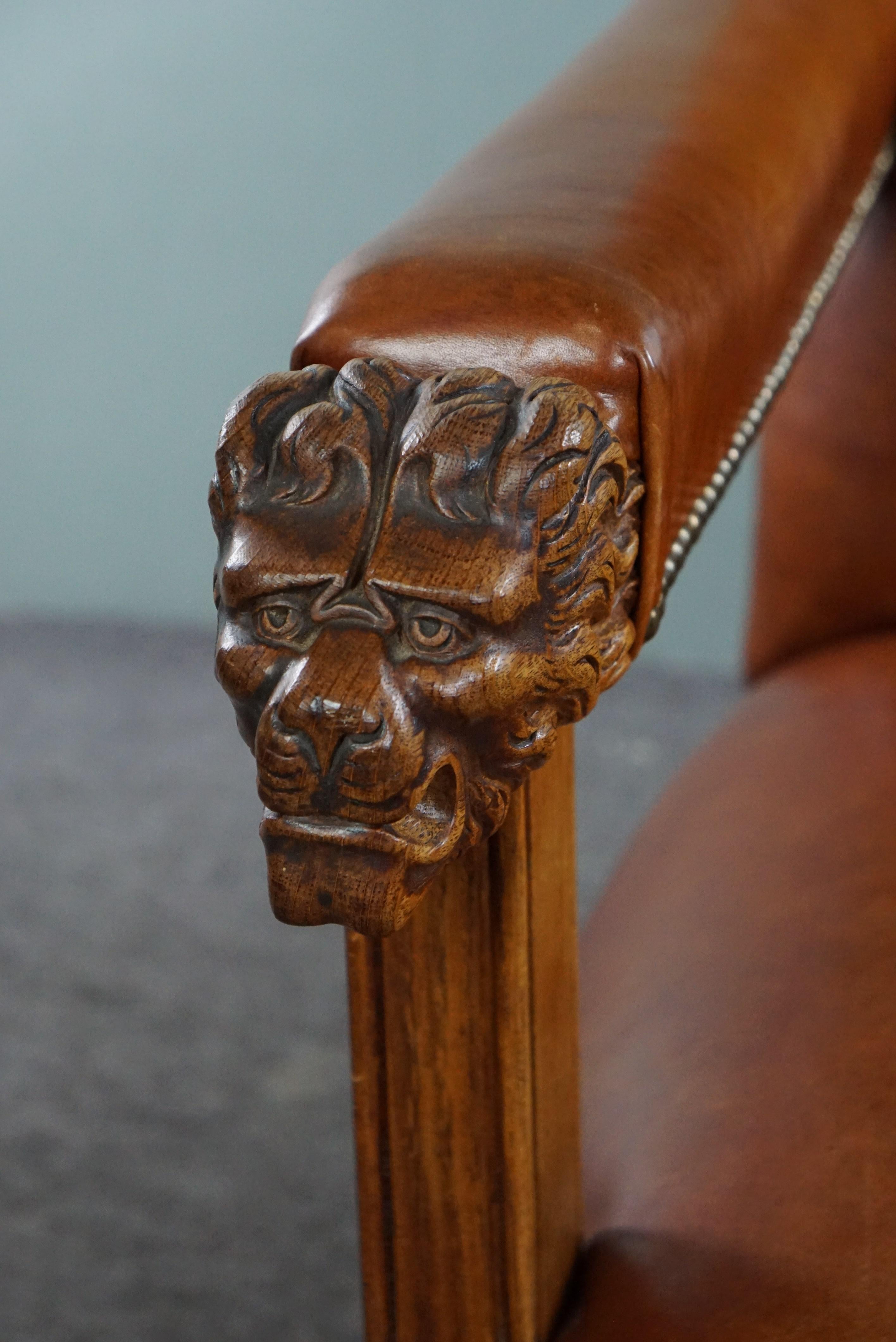Armchair with lion heads reupholstered in cognac-colored cowhide For Sale 3