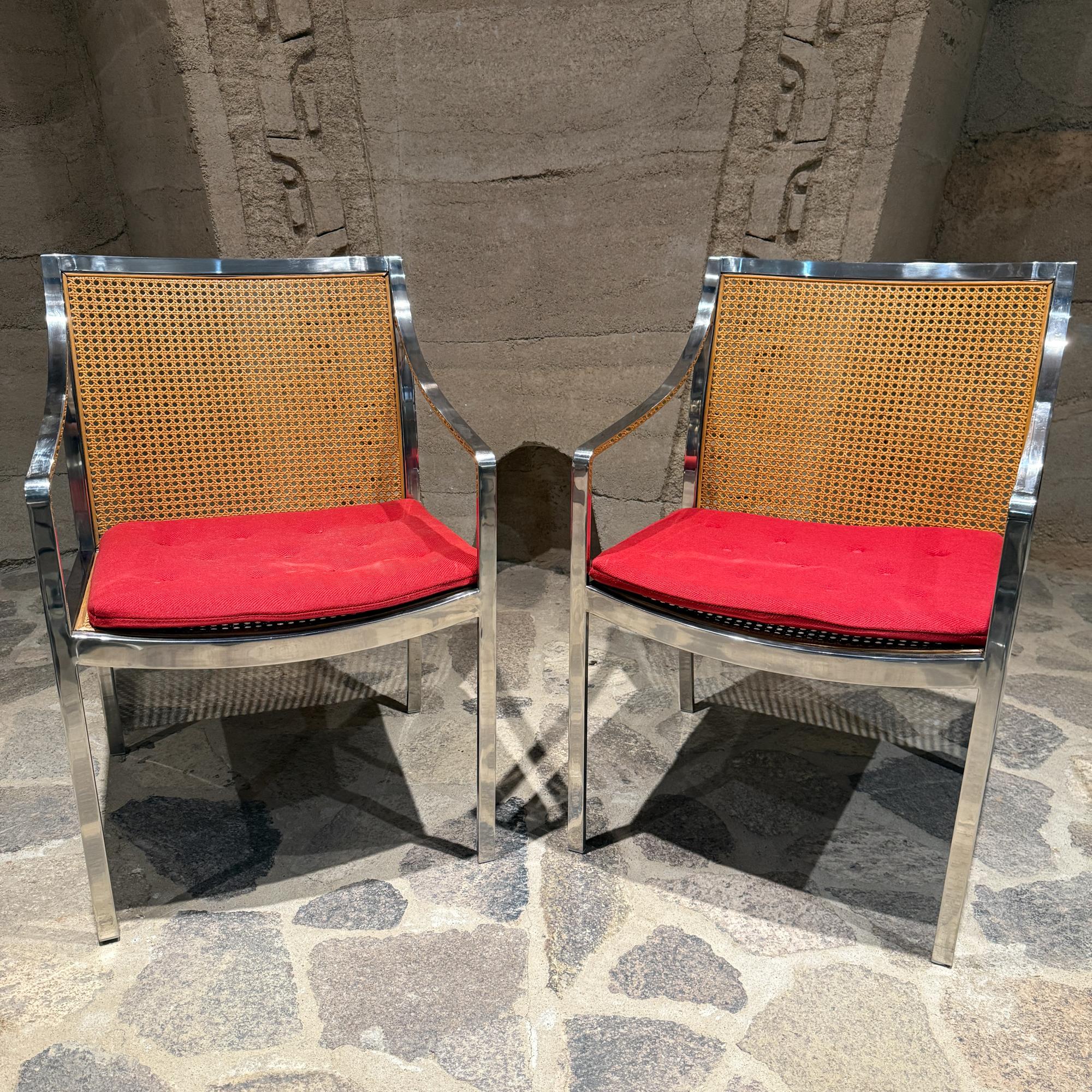 For your consideration, a pair of armchairs attributed to Milo Baughman.Mid-Century Modern chrome and cane armchairs. 
 The chairs feature the minimalist, modern aesthetic popular in the mid-20th century, combining industrial and natural
