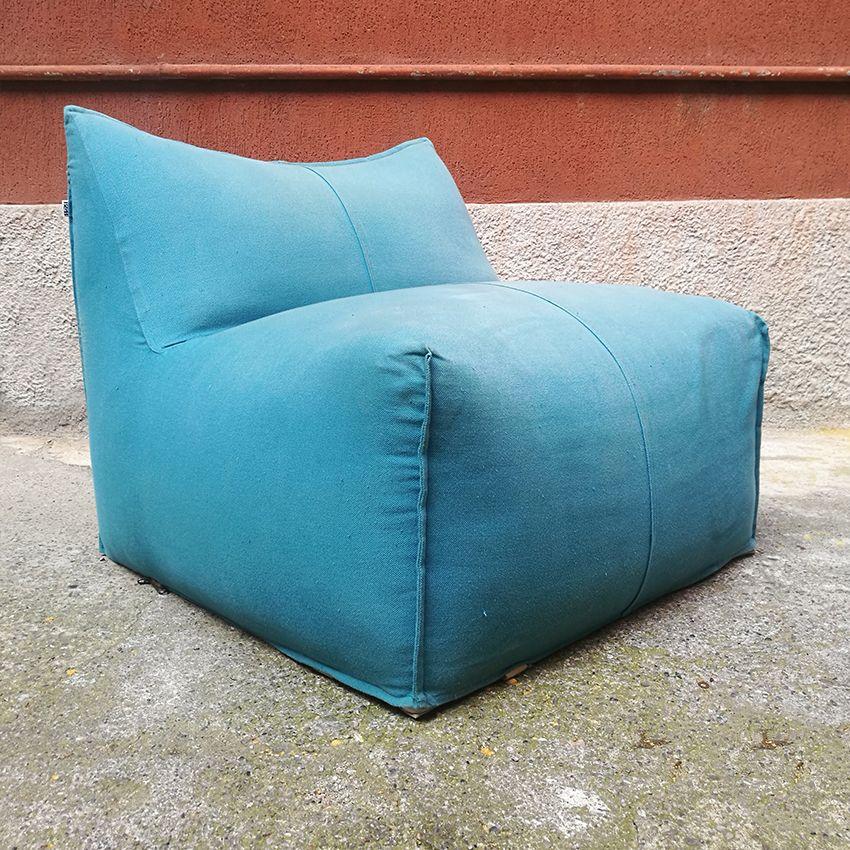 Mario Bellini designed Le Bambole for B&B Italia in 1972, armchairs and sofas shaped in their entirety like large cushions. Combining extraordinary comfort and style, this Bambola lounge chair is upholstered in a vibrant light blue fabric, which