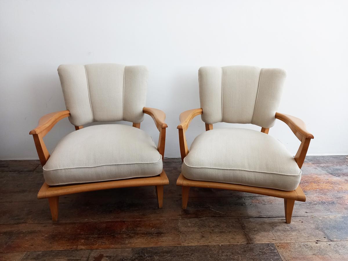 20th Century Pair of French lounge chairs designed by Etienne Henri Martin model sk250. Manufactured by Steiner, circa 1948. Newly reupholstered in a beige linen. 