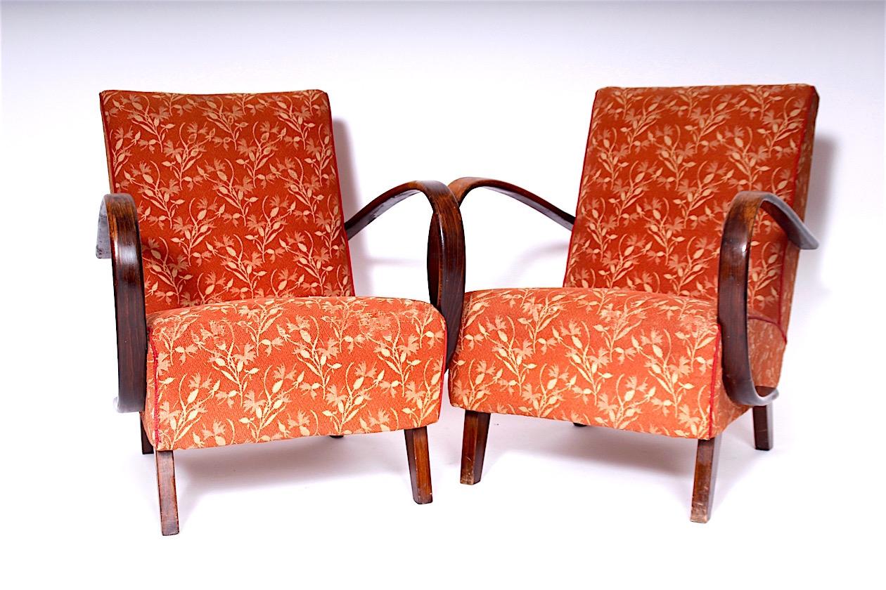 The armchairs are in original condition, the wood has a beautiful patina, the upholstery is worth replacing.