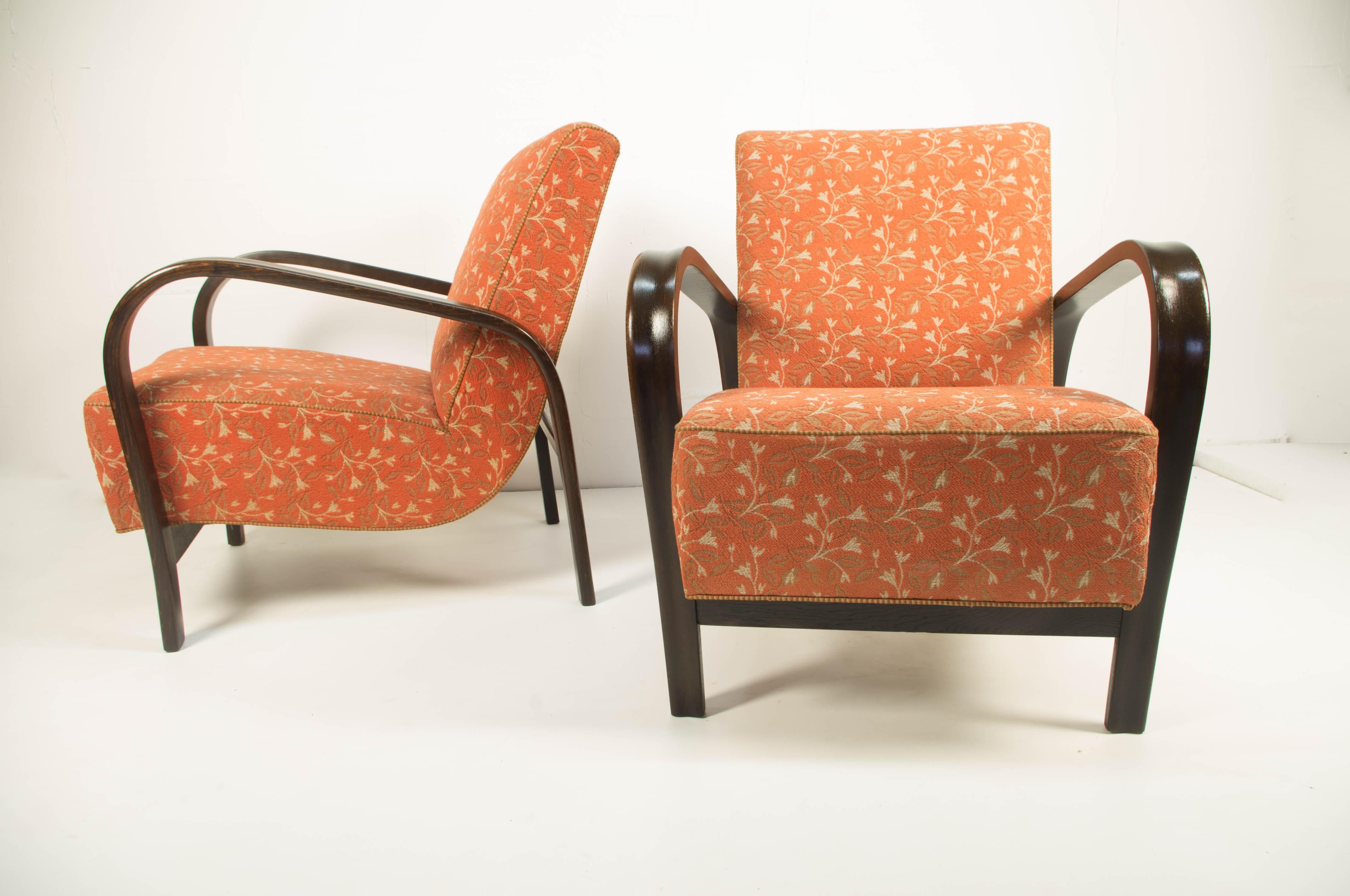 Hardly to find so extremely preserved set of two armchairs by famous Czech designers Karel Kozelka and Antonin Kropacek. Original upholstery with flowered pattern in excellent condition was professionally cleaned. Wooden parts with beautiful patina