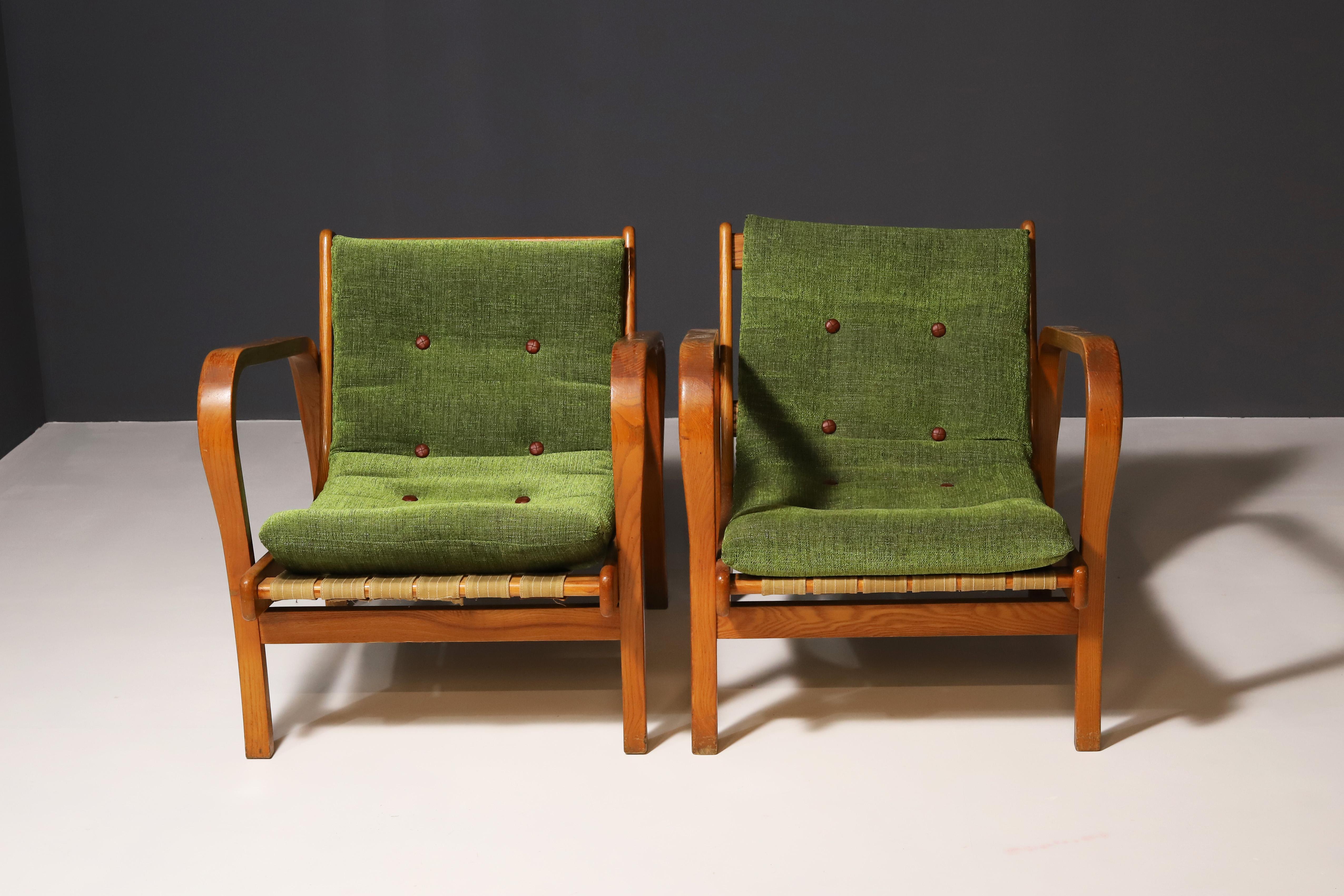 Pair of armchairs designed by Czech designers Antonin Kropacek and Karel Kozelka. This seat model dates from 1944. It is part of a set that was awarded the silver medal at the Milan Triennial in 1946. It is produced by Interier Praha. The cushions