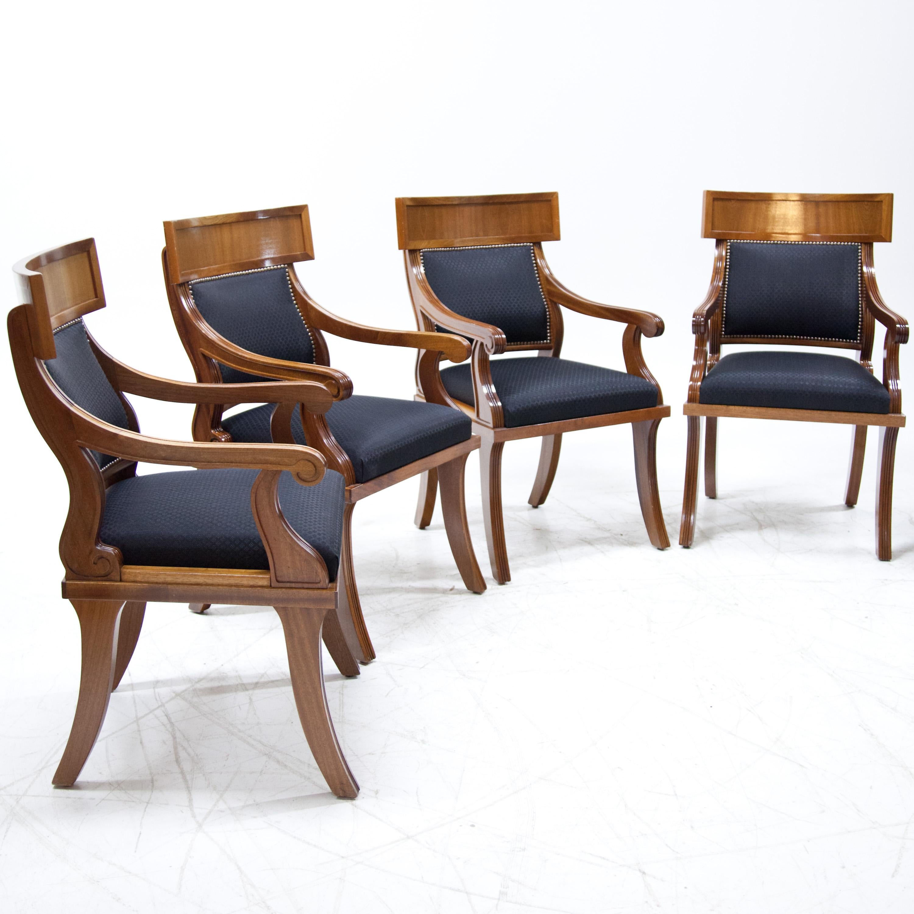 Set of six armchairs in late Biedermeier style with upholstered seat and backrest. These were newly covered with a dark blue fabric with a diamond pattern, the backrest was additionally decorated with rivets.