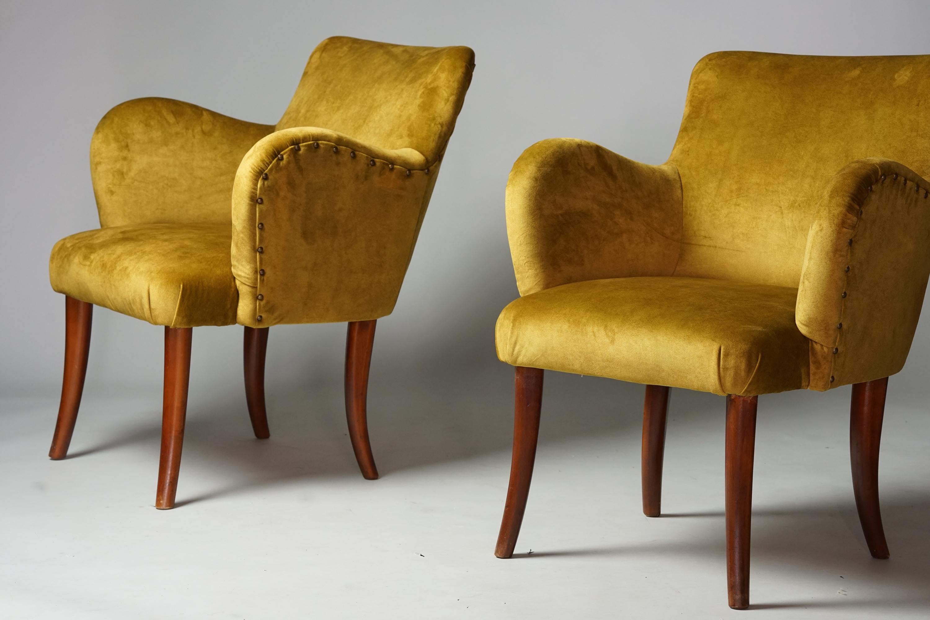 Armchairs in Gunnel Nyman Style, 1940s. Stained birch legs, reupholstered with quality velvet like -fabric. Metal details. Good vintage condition, minor patina consistent with age and use. The armchairs are sold as a set. 