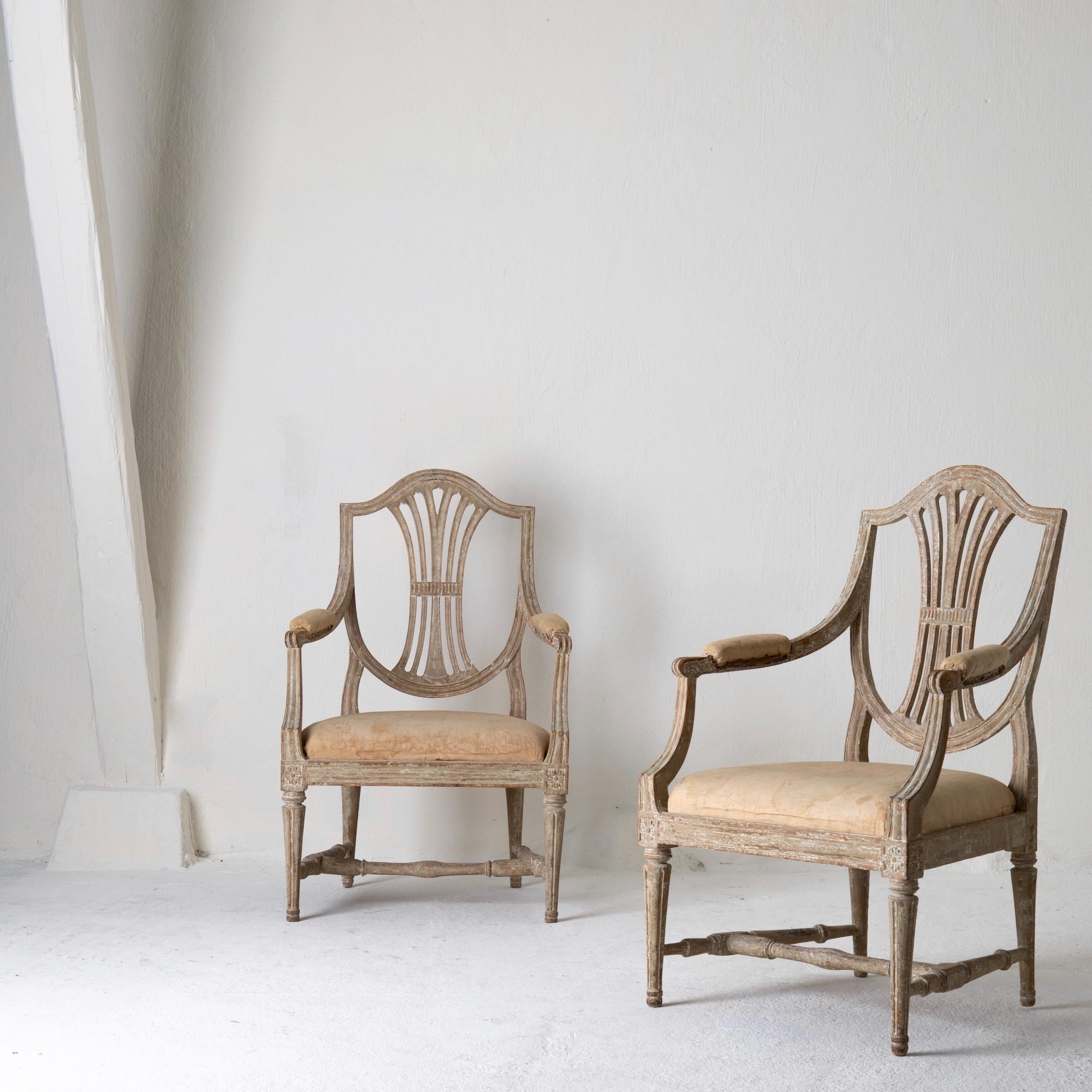A pair of armchairs made during the Gustavian period in Sweden 1790-1810. Stripped to their original greenish gray finish. Beautiful carvings.

 