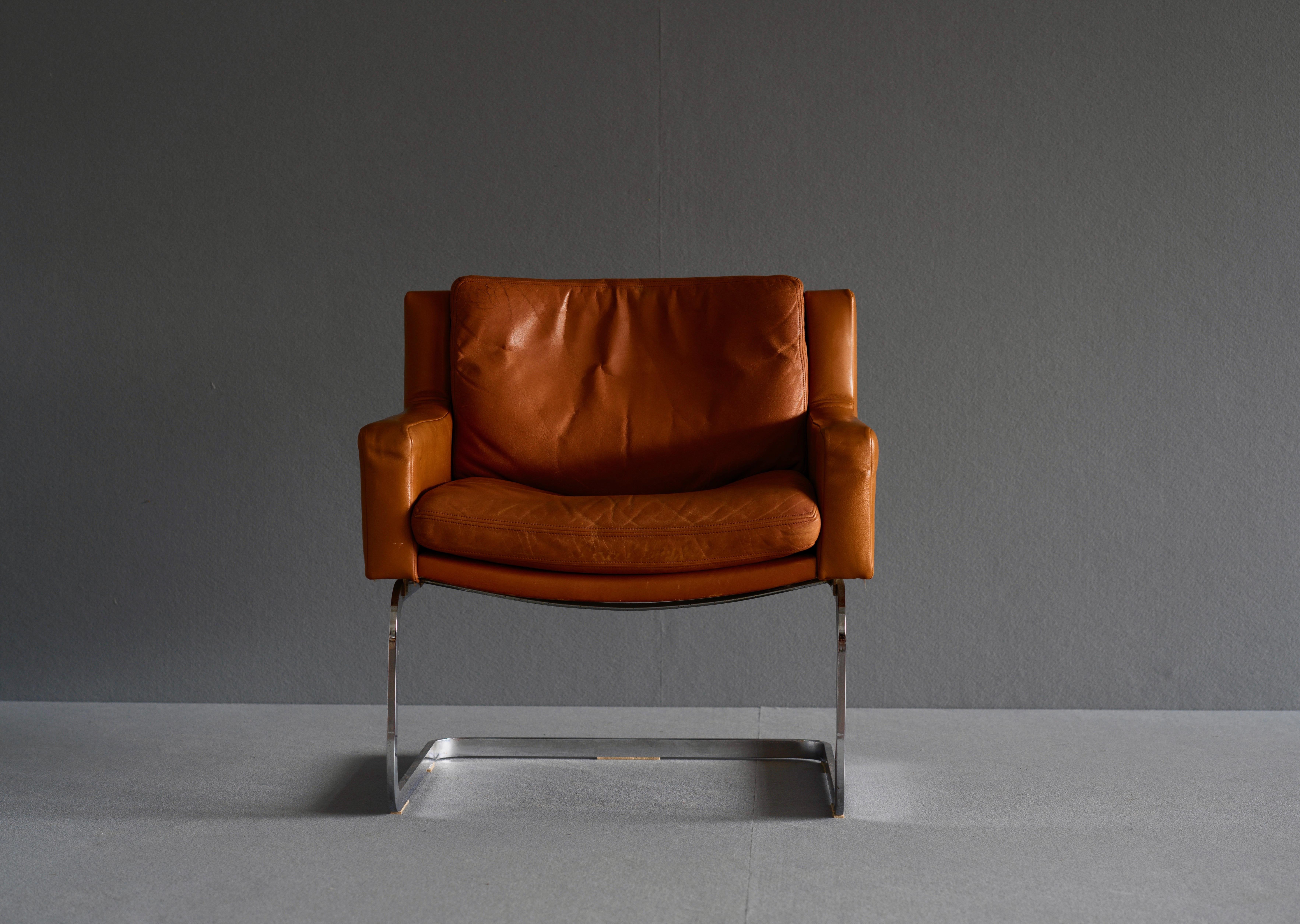Armchairs designed by Roberts Haussmann for De Sede. The chairs feature a cantilever design and have a chromed steel frame. They are upholstered in fabulously patinated cognac leather. As with all De Sede pieces the chairs feature top quality
