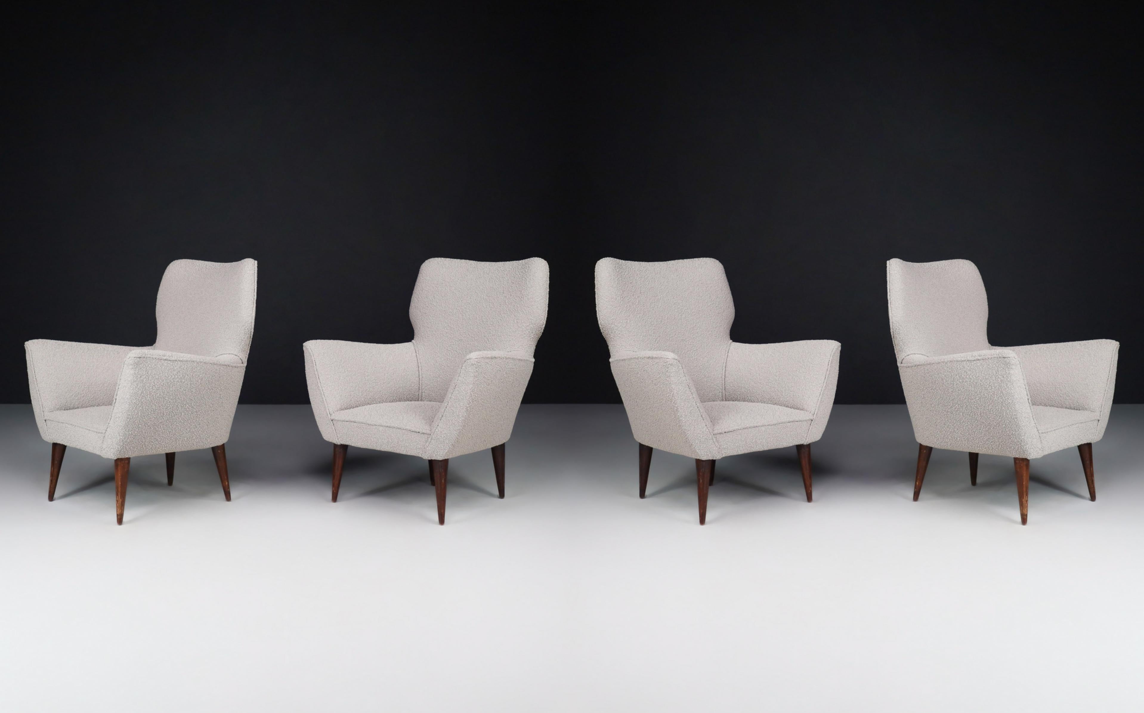 Armchairs with Tapered Wooden Legs in the style of Gio Ponti, Italy, in the 1950s. 

Large set armchairs with tapered wooden legs in new upholstery in the style of Gio Ponti designed and produced in the 1950s in characteristic Italian style.