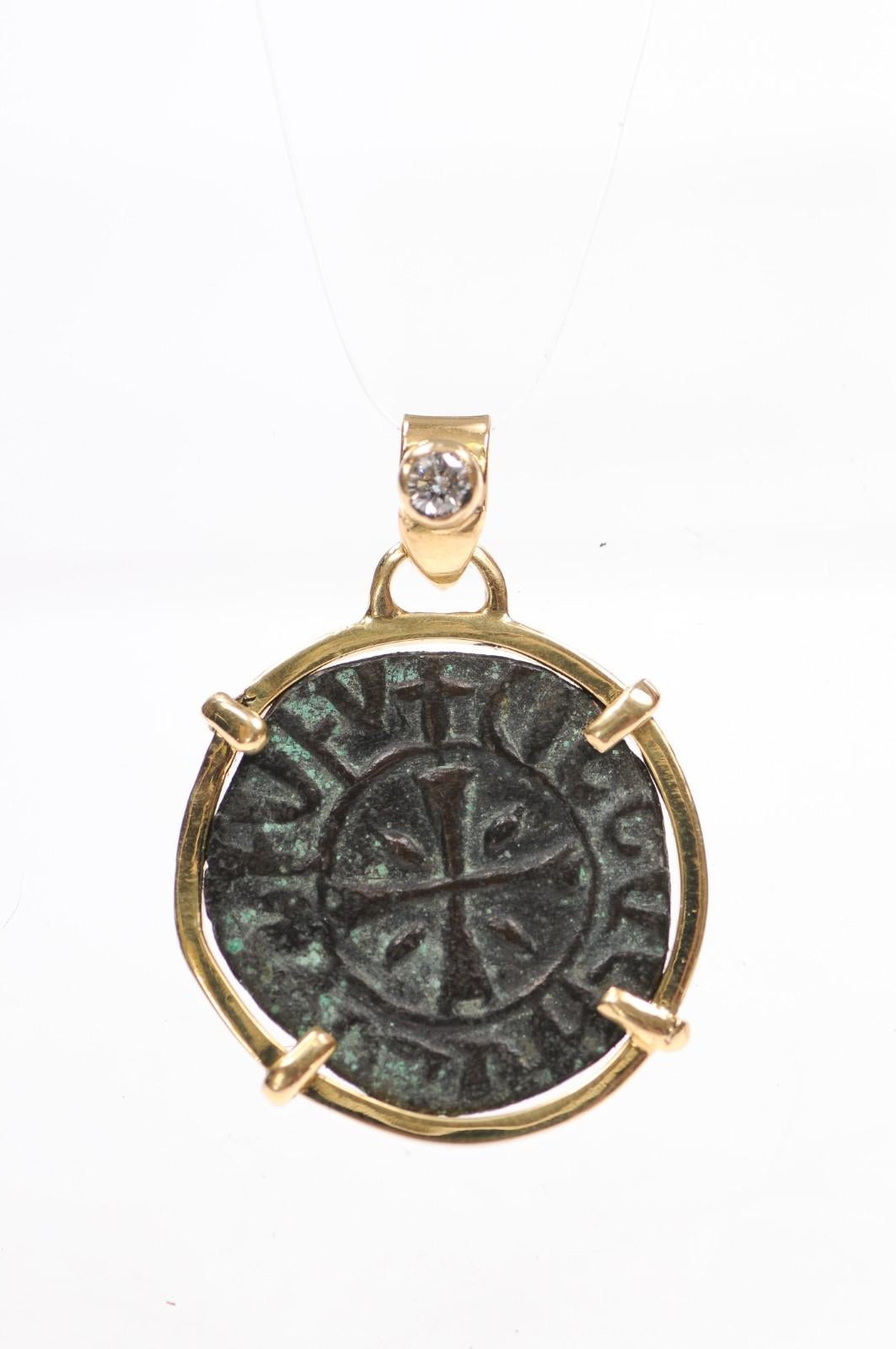 An ancient Armenian Coin, from the Cilician Kingdom, made sometime during the age of the Crusades, 1098 AD -1375 AD. This is a beautifully defined cross trimmed in 18 karat gold with prominent verdigris on the copper. The coin is further embellished