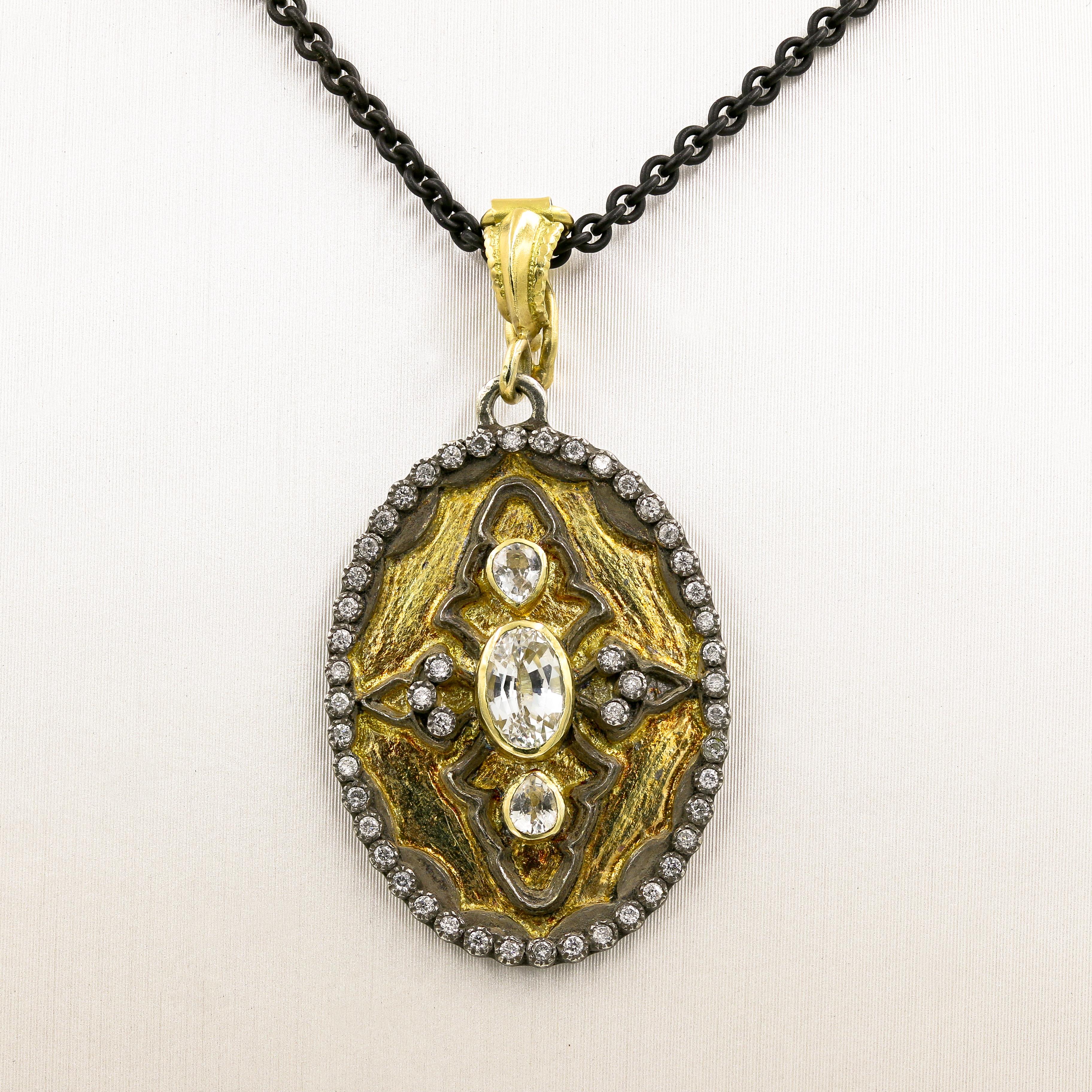 This unique necklace is an 18kt. yellow gold and blackened 