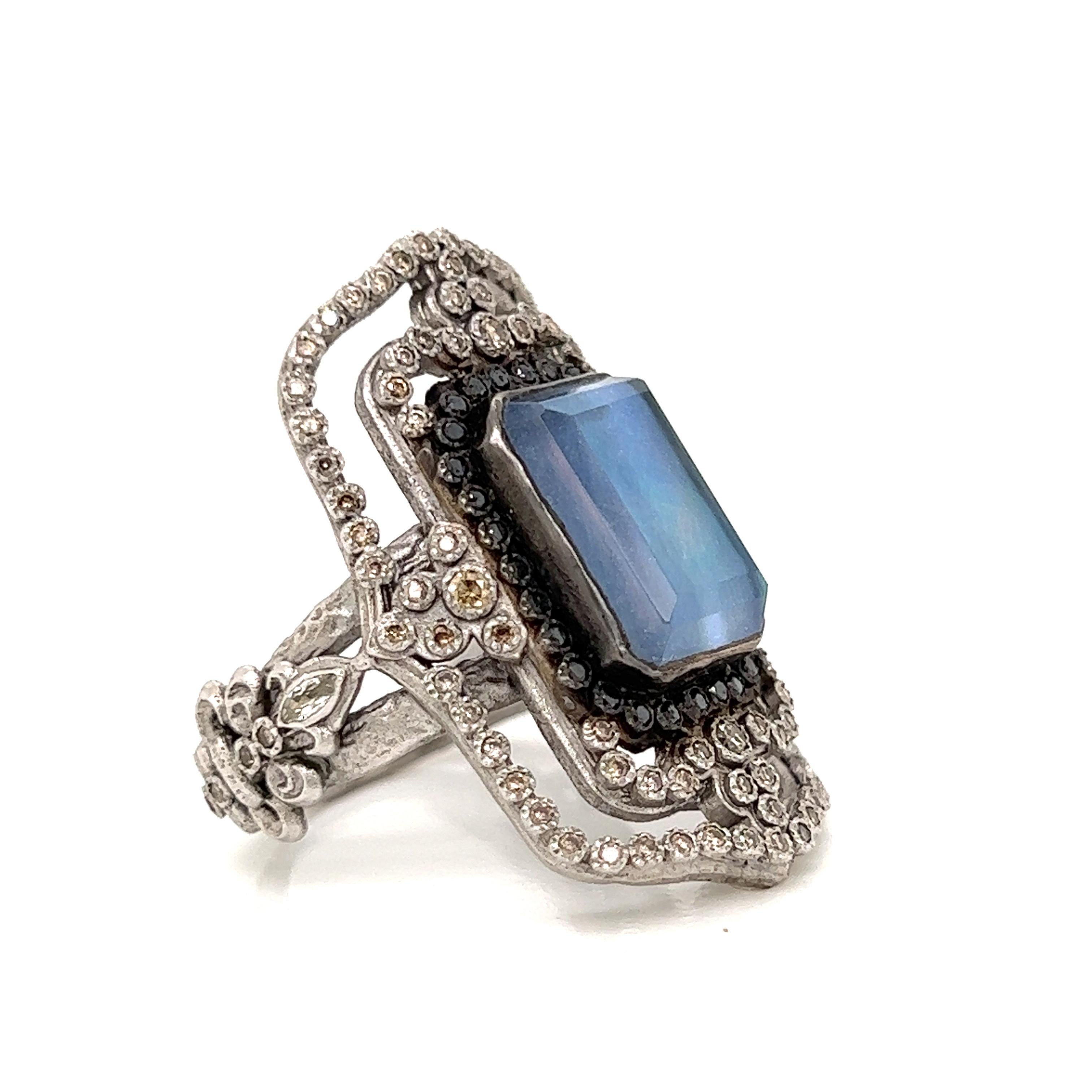 This Armenta ring makes a statement! Gorgeous attention to detail and styling with a vintage vibe. A large blue-gray-aqua mother of pearl sapphire is accented with black, champagne and white diamonds.  This is a US size 6 and can be sized. Set in