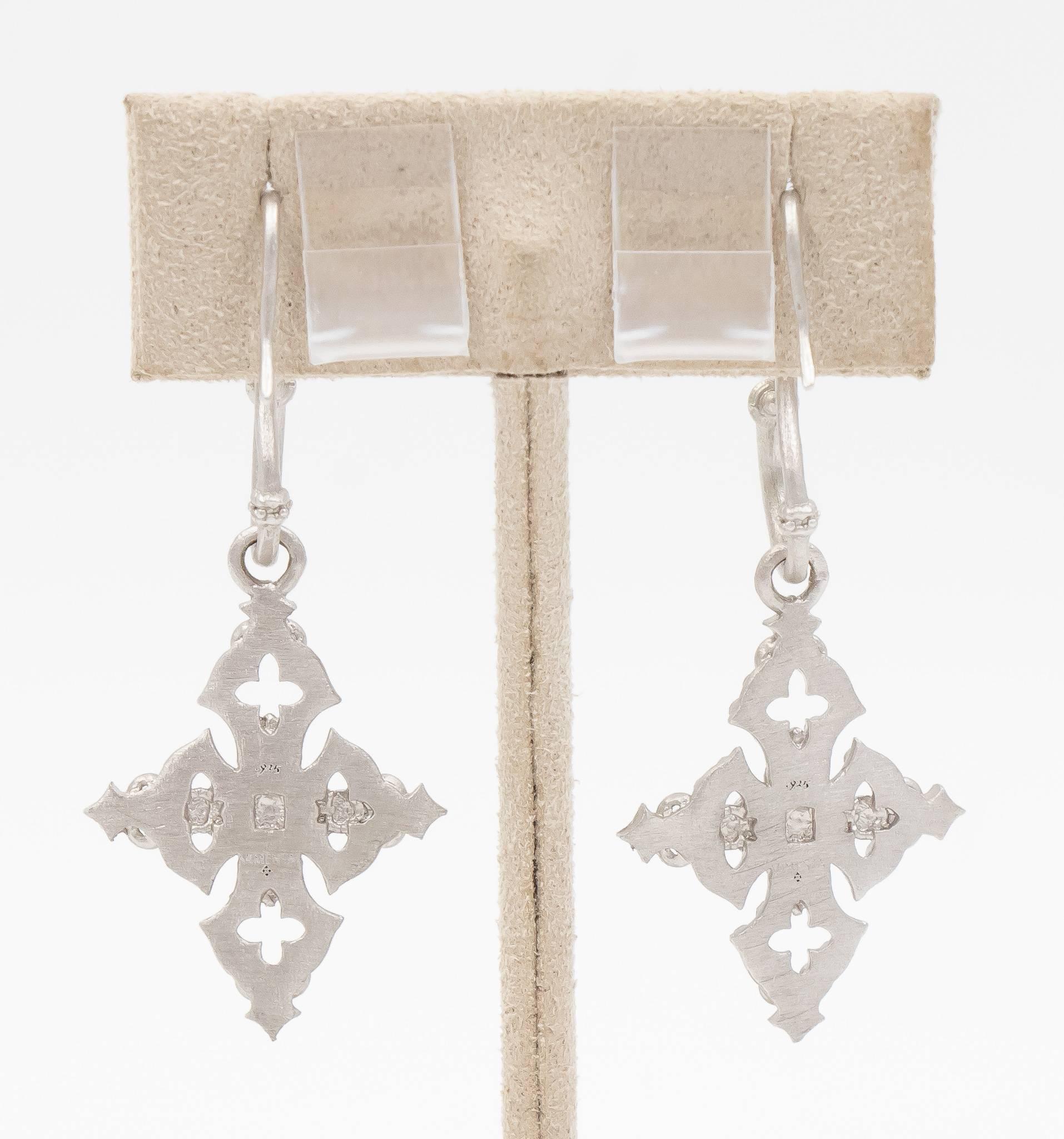 These Armenta New World drop earrings are dazzling with 0.22 carats of round brilliant diamonds set throughout the uniquely finished silver which gives this a signature look. The center diamond set in the cross is a fine quality champagne diamond. 
