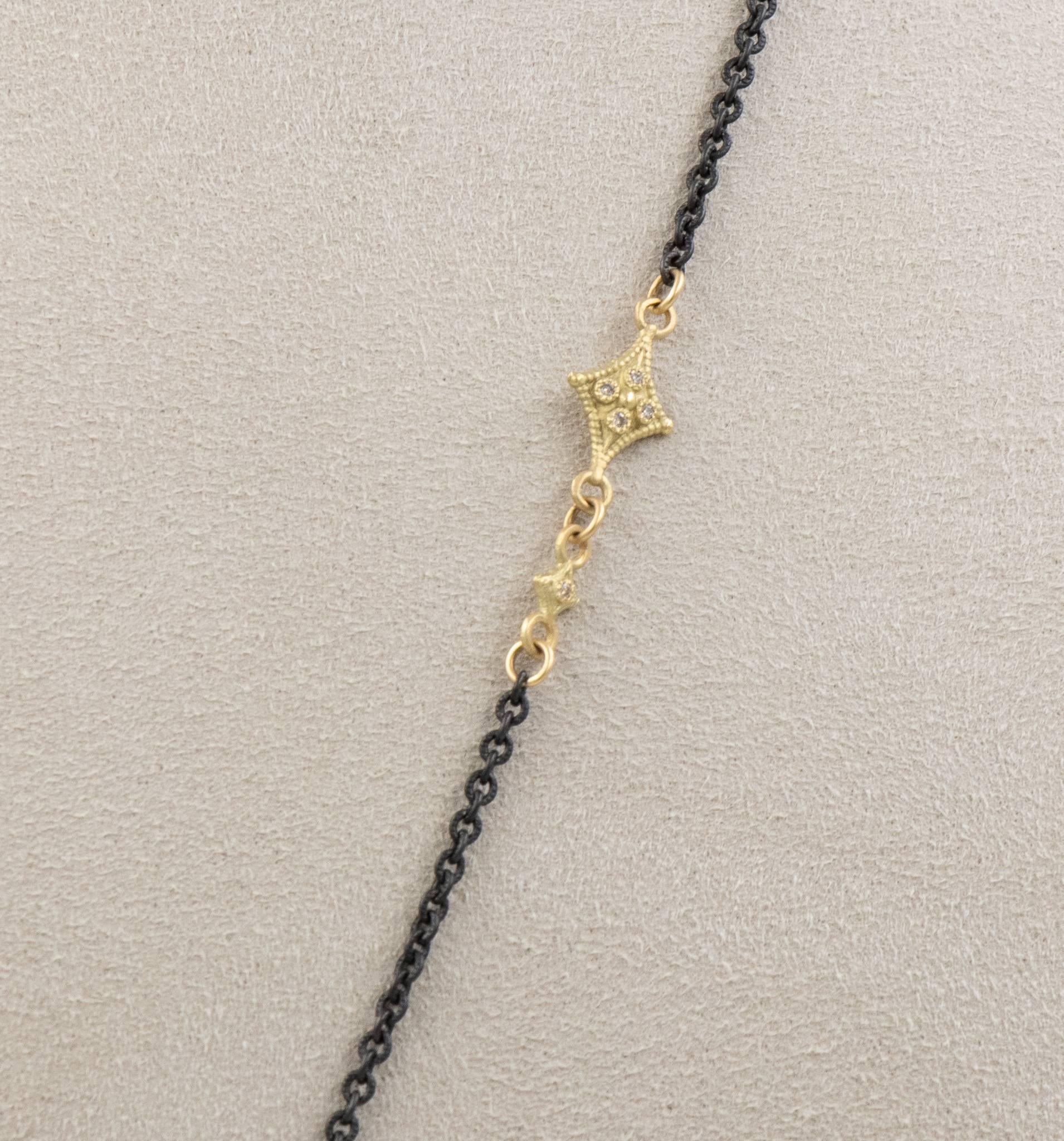 This Armenta lariat necklace from the Old World collection features a 22 inch blackened sterling silver chain with 18 karat yellow gold accents. It also has 12mm bead pendant with pave-set diamonds. 

Internal Measurements:

Total Carat Weight: