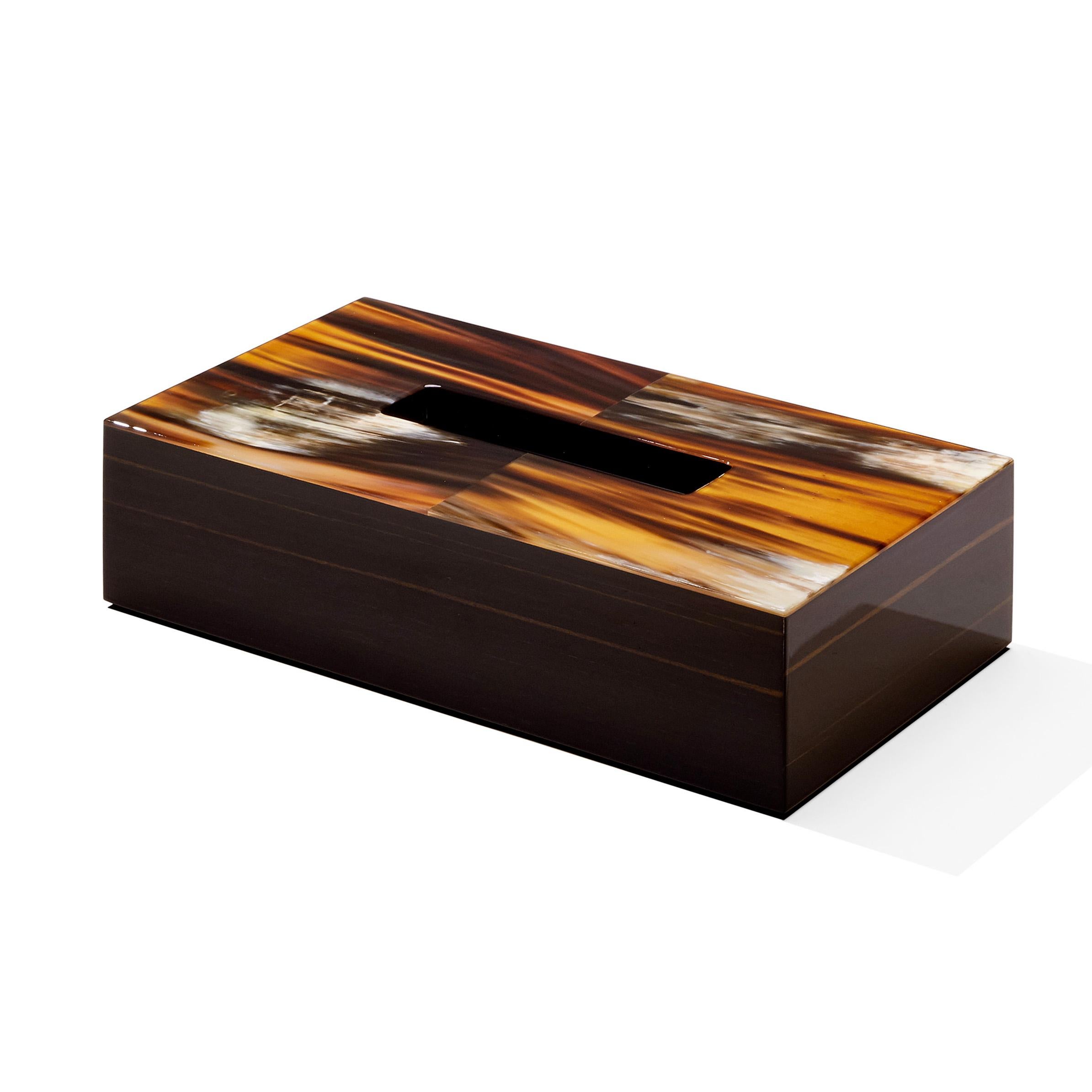 An elegant reinterpretation of an everyday object, the Armida tissue box holder is distinguished by a rectangular silhouette in glossy ebony with a sophisticated top in brown veined Corno Italiano. Designed to fit standard tissue box refill, it will