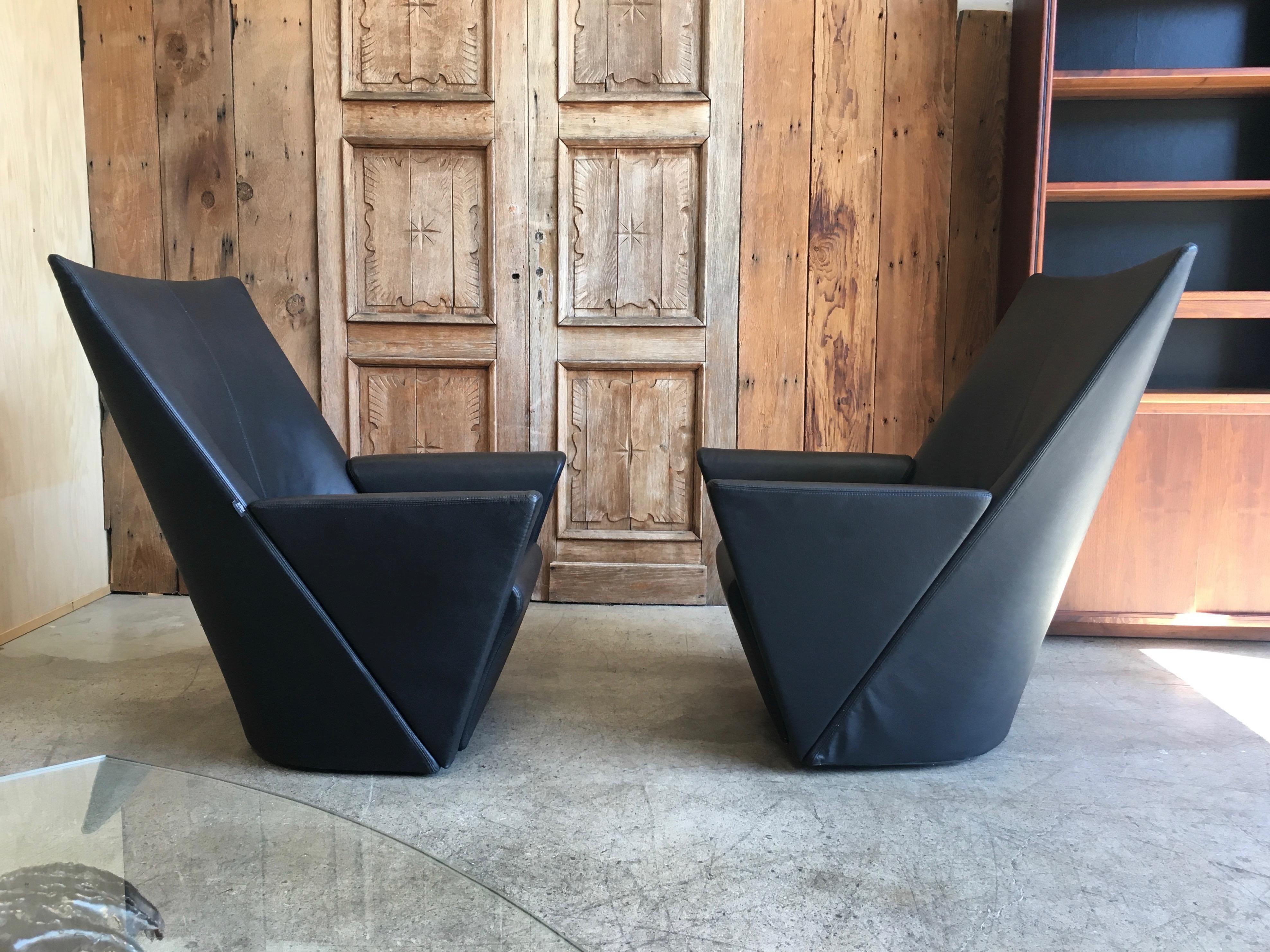 Pair of swivel chairs and ottoman in textured black Italian leather    The ottoman Dimensions: 20 L x 18.5 D x 16 H.
