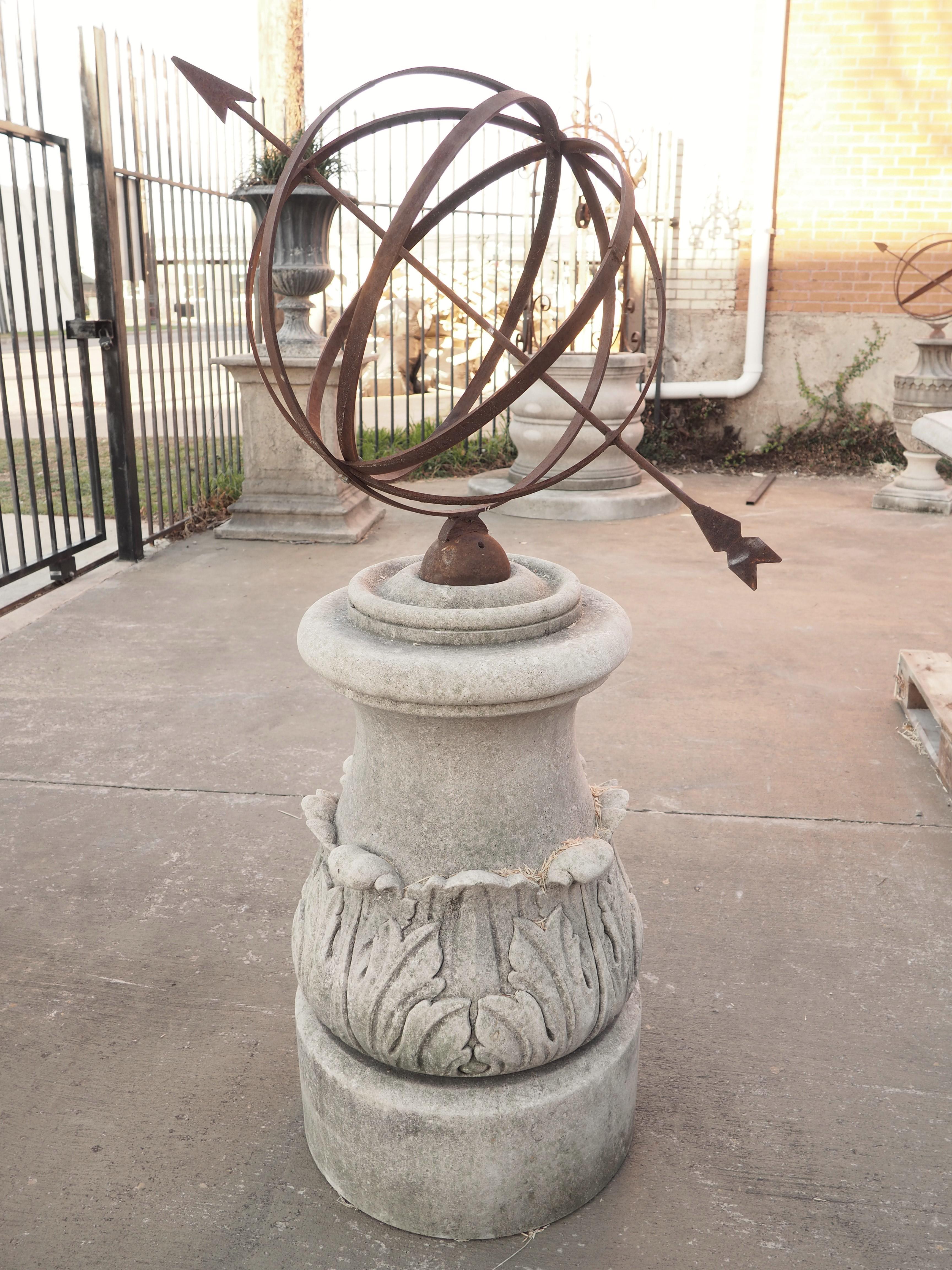 This hand carved limestone armillary sundial with carved acanthus leaf décor and wrought iron sphere will make a grand statement in any garden. Invented by the Greeks in the third century BC, the original armillary spheres were earth-centric, which
