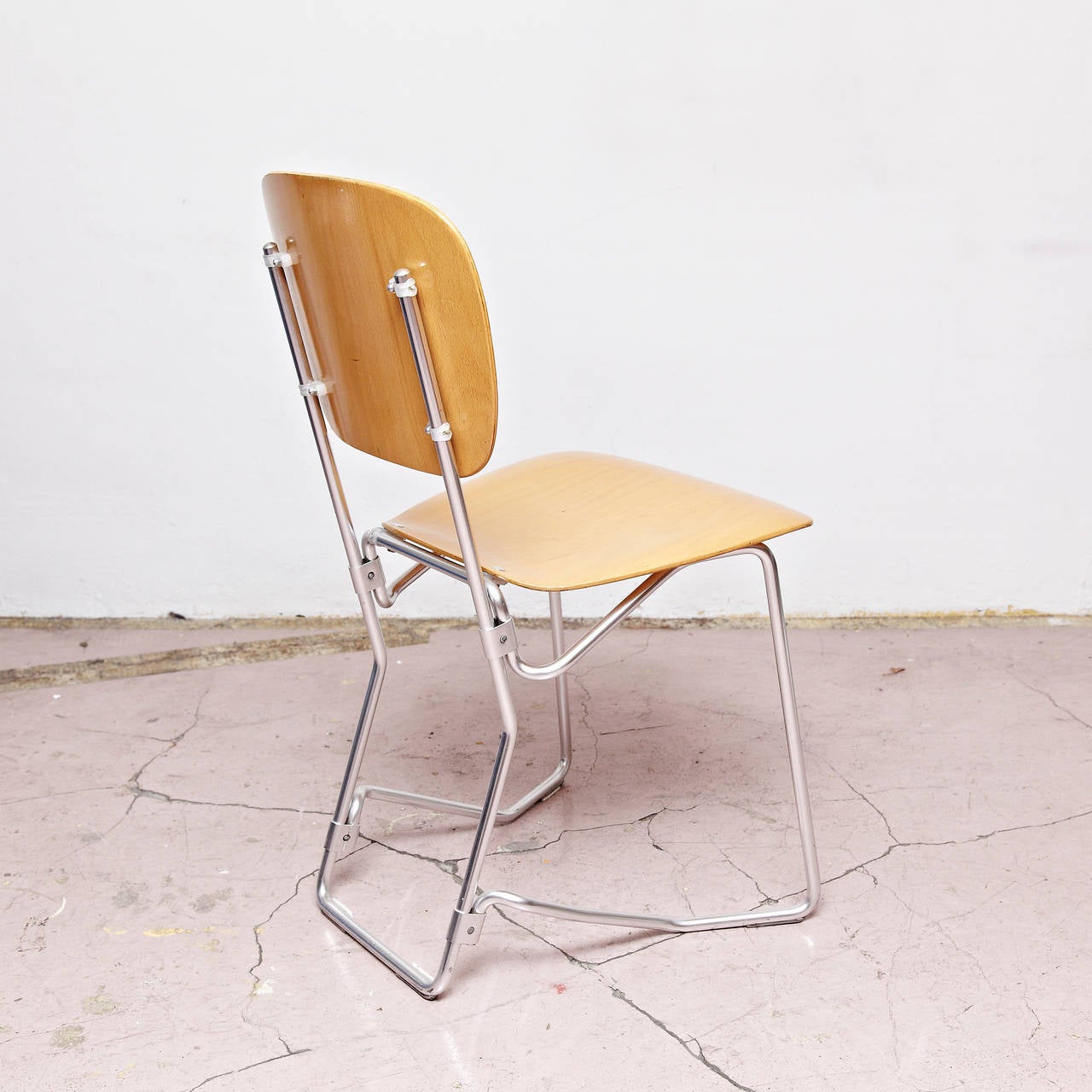 Stackable Aluflex chairs designed by Armin Wirth.
Manufactured by Aluflex, Switzerland, circa 1950. 

Metal and plywood.

In good original condition, with minor wear consistent with age and use, preserving a beautiful patina.

4 chairs