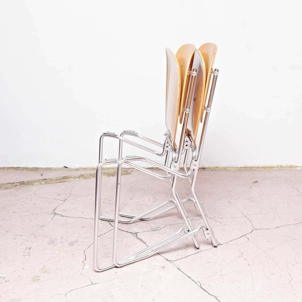 Stackable Aluflex chairs designed by Armin Wirth.
Manufactured by Aluflex, Switzerland, circa 1950.

Metal and plywood.

In good original condition, with minor wear consistent with age and use, preserving a beautiful patina.

4 chairs