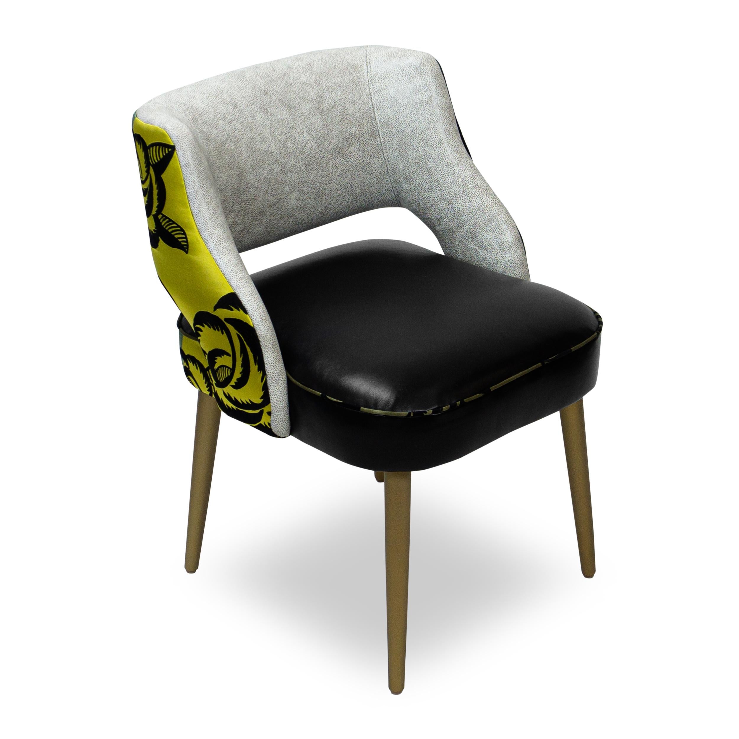 Original dining chair design with black faux leather seat, pebbled grey faux leather inside back and large scale floral jacquard outside back and contrast welting. Legs sprayed with a pearlized faux metallic paint. Our best selling design, this