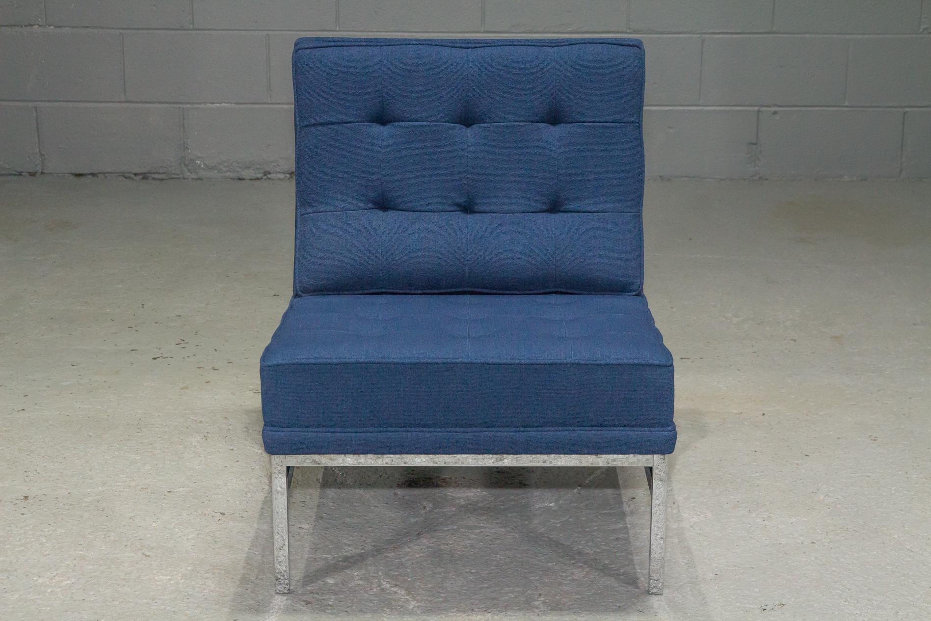Armless lounge chair by Florence Knoll upholstered in blue fabric with chrome legs and supports.