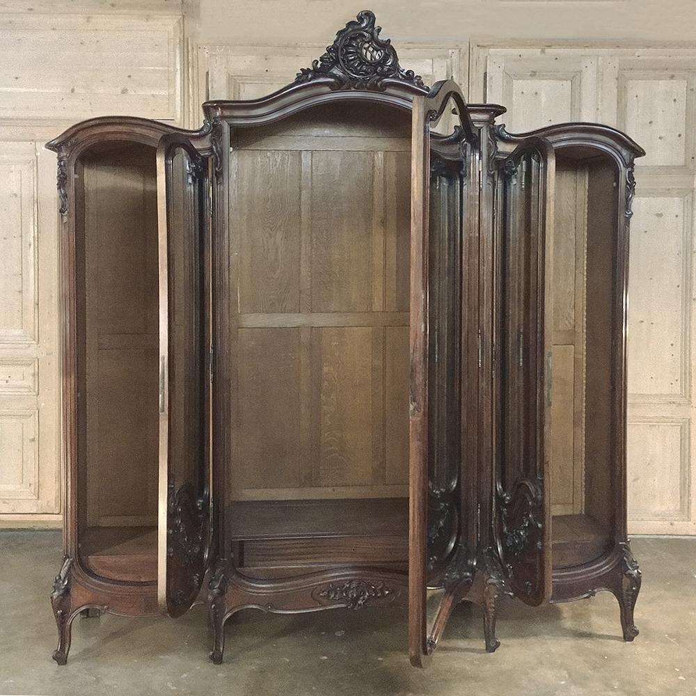 19th century French Louis XV walnut triple armoire by Mercier Freres in Paris was crafted by one of the world-renowned Parisienne furniture crafters of the Belle Époque, a time which many experts believe produced the finest furniture in all of