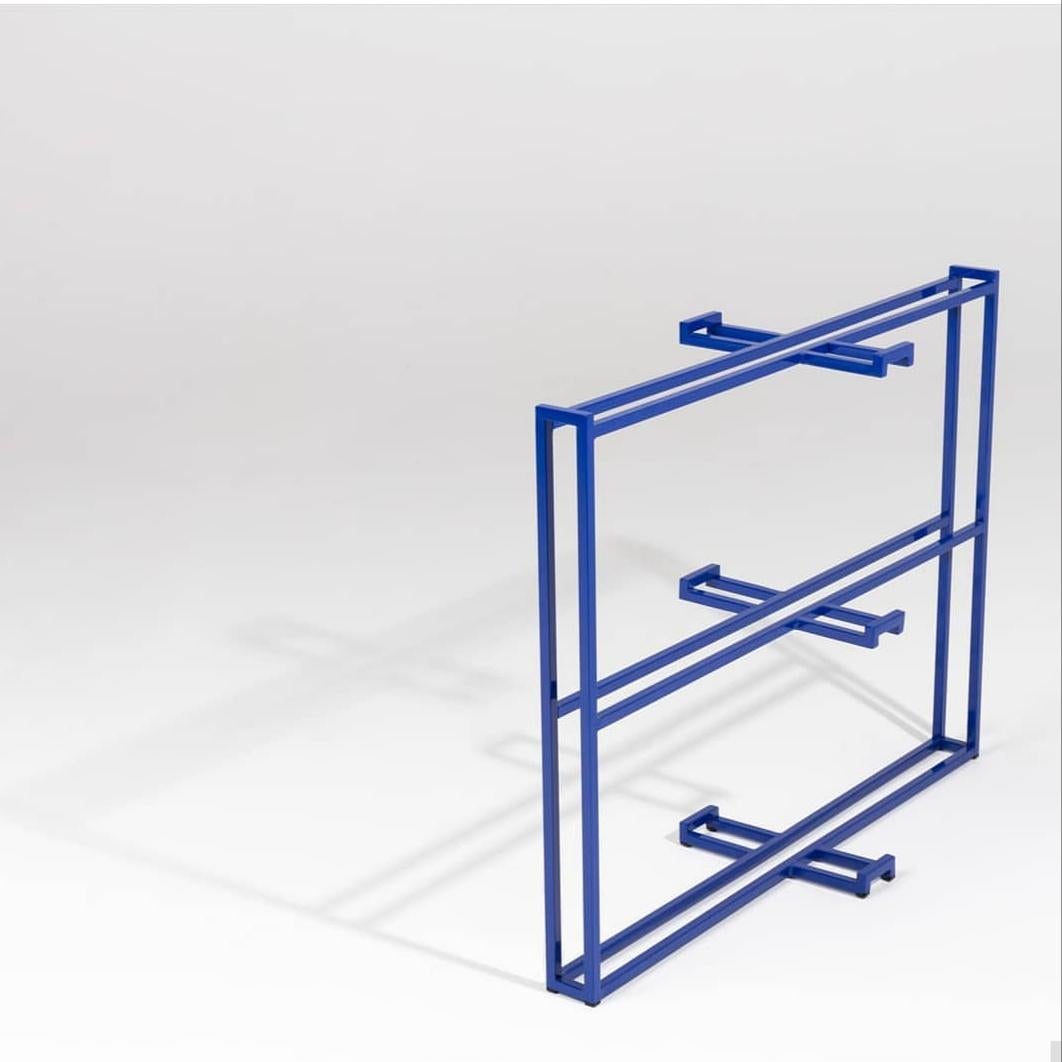 Shelf/cabinet designed by Armombiedro Studio. Blue lacquered iron structure with black marble shelves.