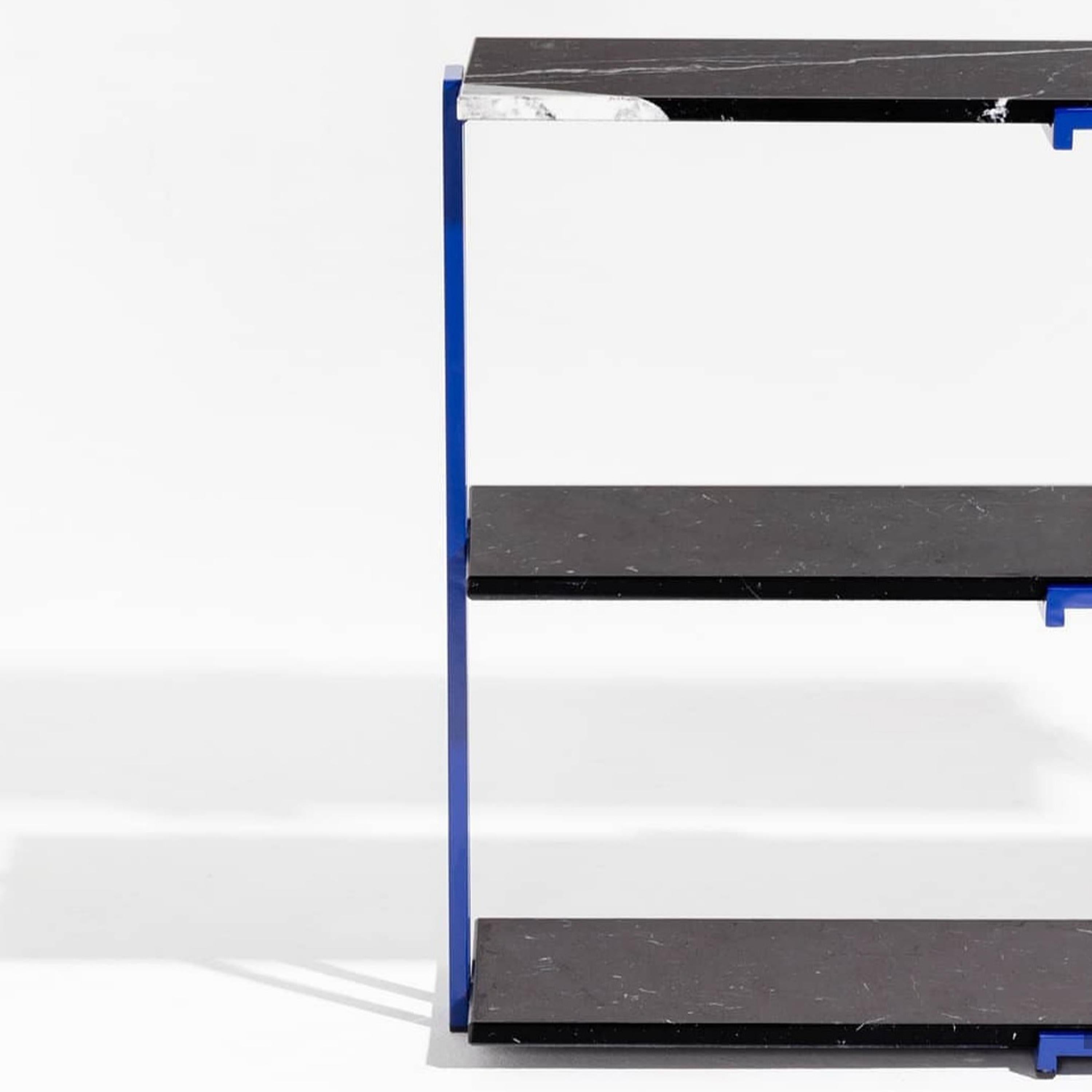 Shelf designed by Ángel Armombiedro. Rectangular metal blue lacquered structure with three shelves
and natural black Marquina marbel.