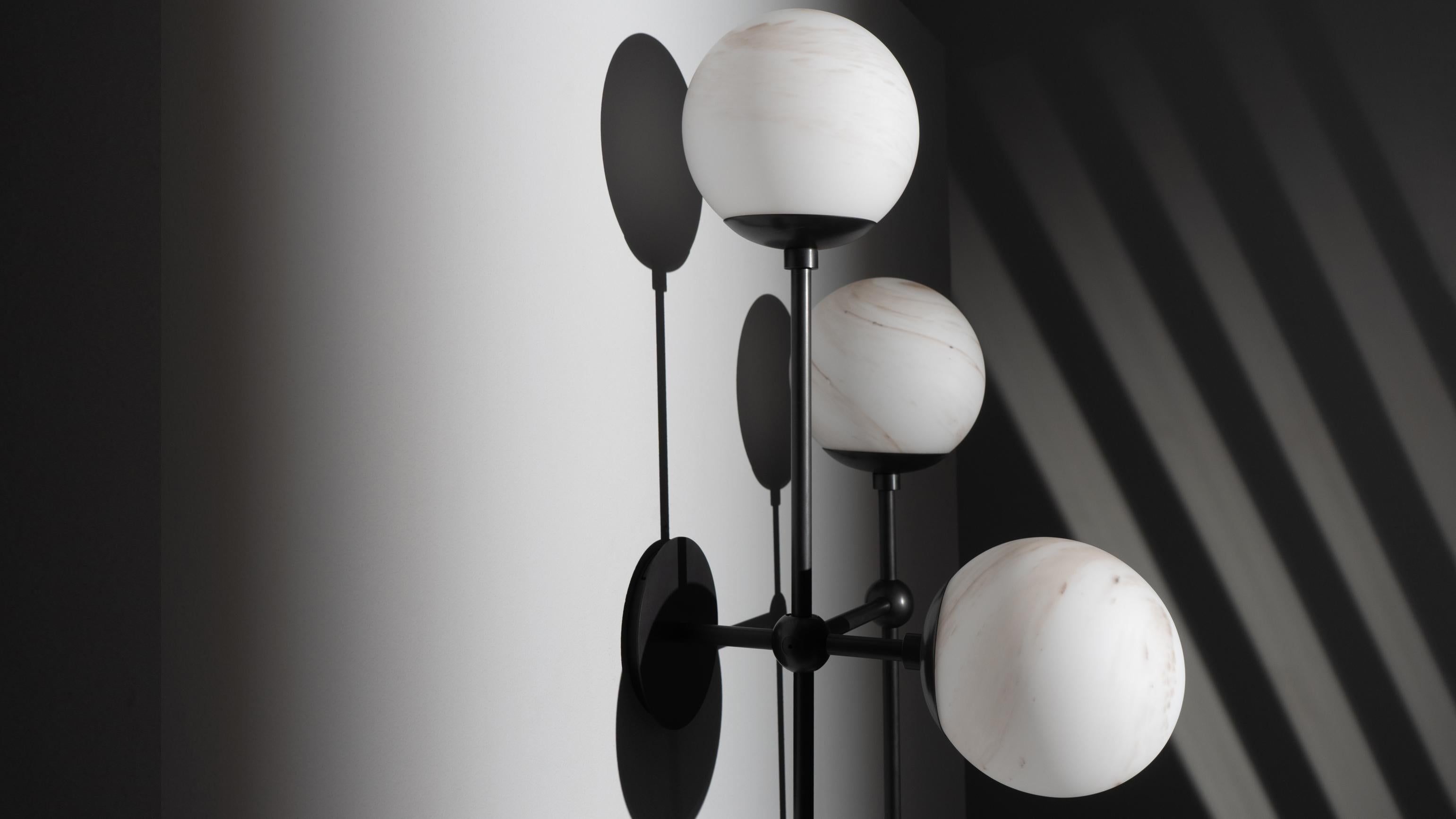 Gravity-defying playfulness requires technical precision. Suggestive minimalism of connective nodes creates a grid-like metal structure-- punctuated by four glass globes.

Available in our three signature finishes: Lacquered Burnished Brass (LBB);