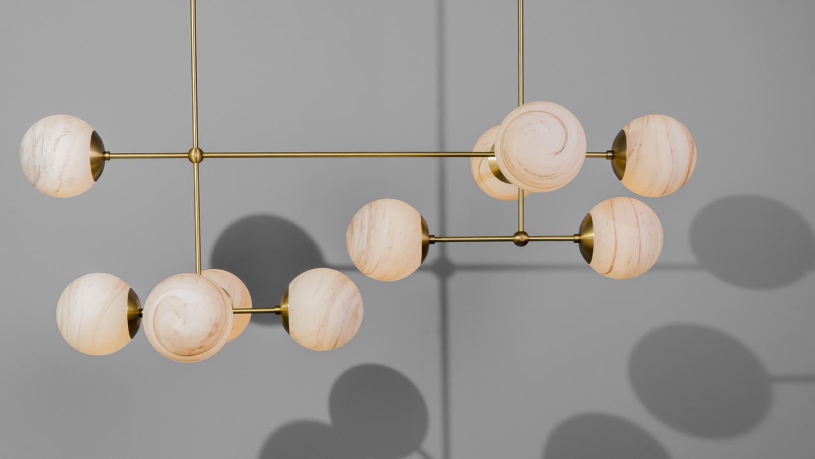 Armstrong Linear captures a sense of movement. Forms connect with spontaneous energy, punctuated by glass spheres. Linear elements complement the carefully crafted brass, echoing a reinforced internal skeleton.

Available in our three signature