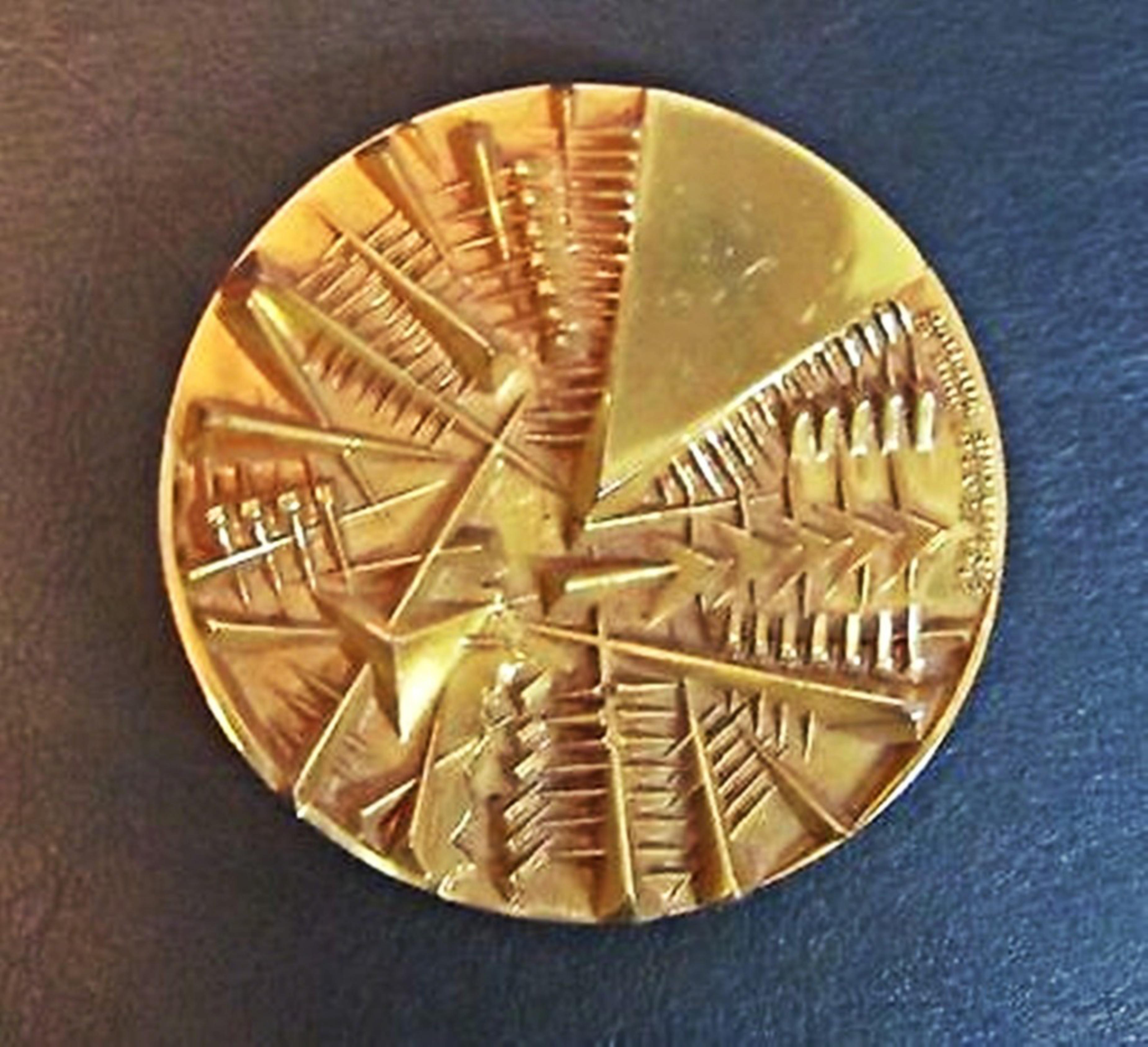 ARNALDO POMODORO
Double Sided Gold Plated Medallion, 1985
Bronze with Gold Patina
2 7/10 × 2 7/10 × 3/10 inches
Limited Edition of 500
Signed by artist with incised signature; Stamped by Johnson Foundry 
This dazzling two sided limited edition