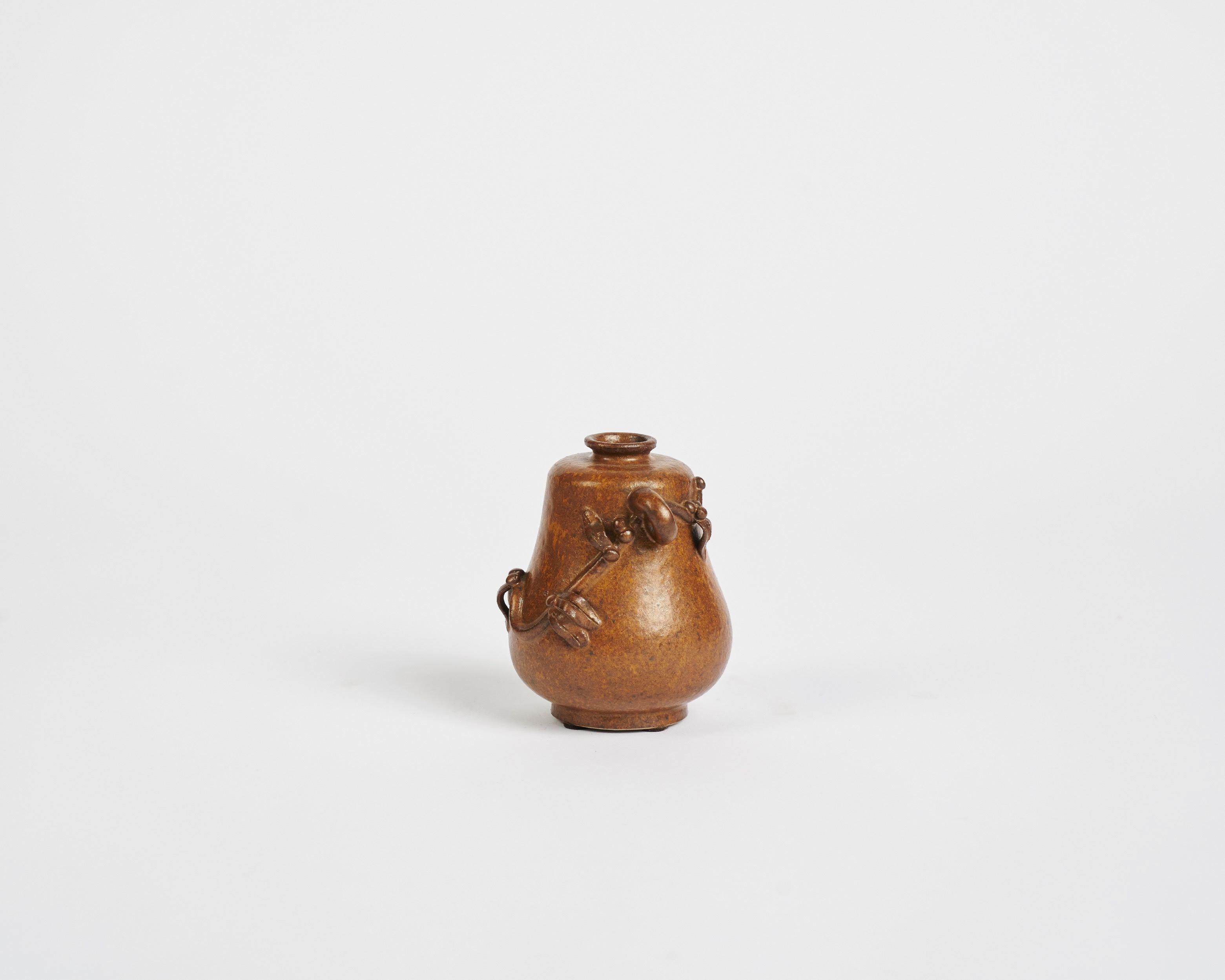 Glazed stoneware vase with vine motif by Arne Bang.

Signed: AB.