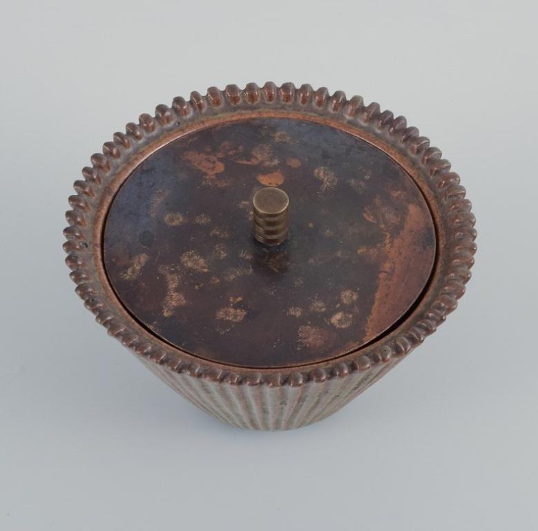 Scandinavian Modern Arne Bang. Ceramic vase with lid in patinated brass.  For Sale
