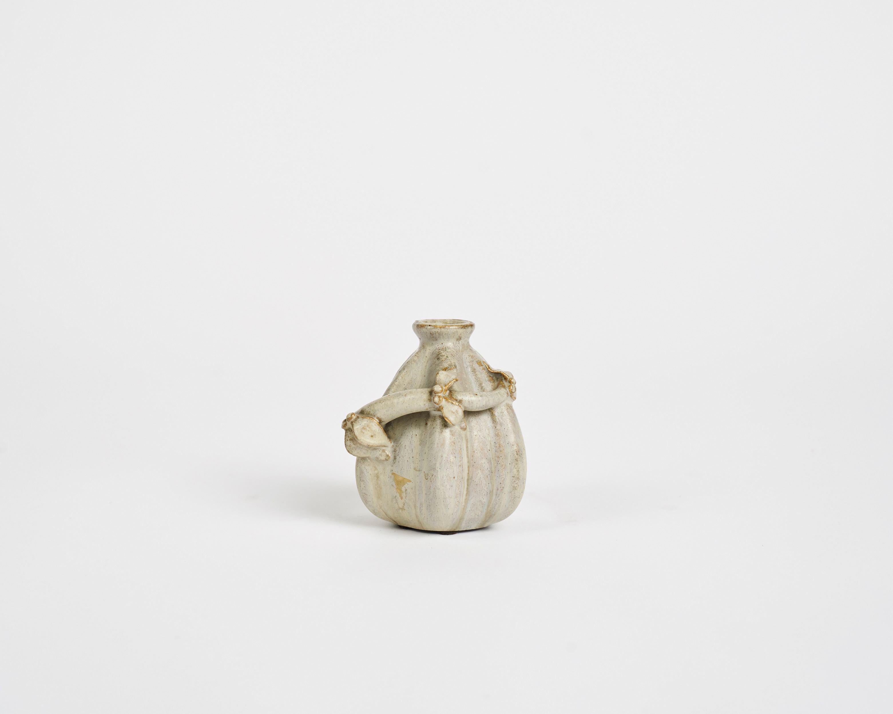 Glazed stoneware vase with vine motif by Arne Bang.

Signed: AB.