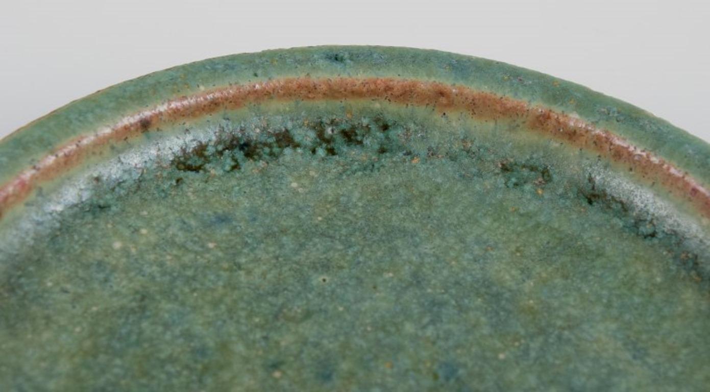 Glazed Arne Bang, own workshop. Small ceramic dish decorated in blue-green glaze.
