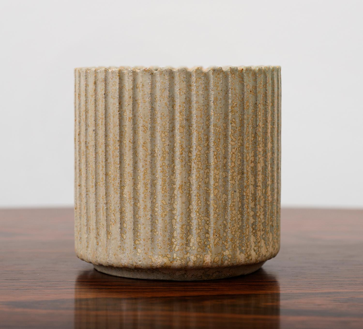 Small circular stoneware vase by Arne Bang with fluted exterior in a bisque glaze, Denmark, 1950s.