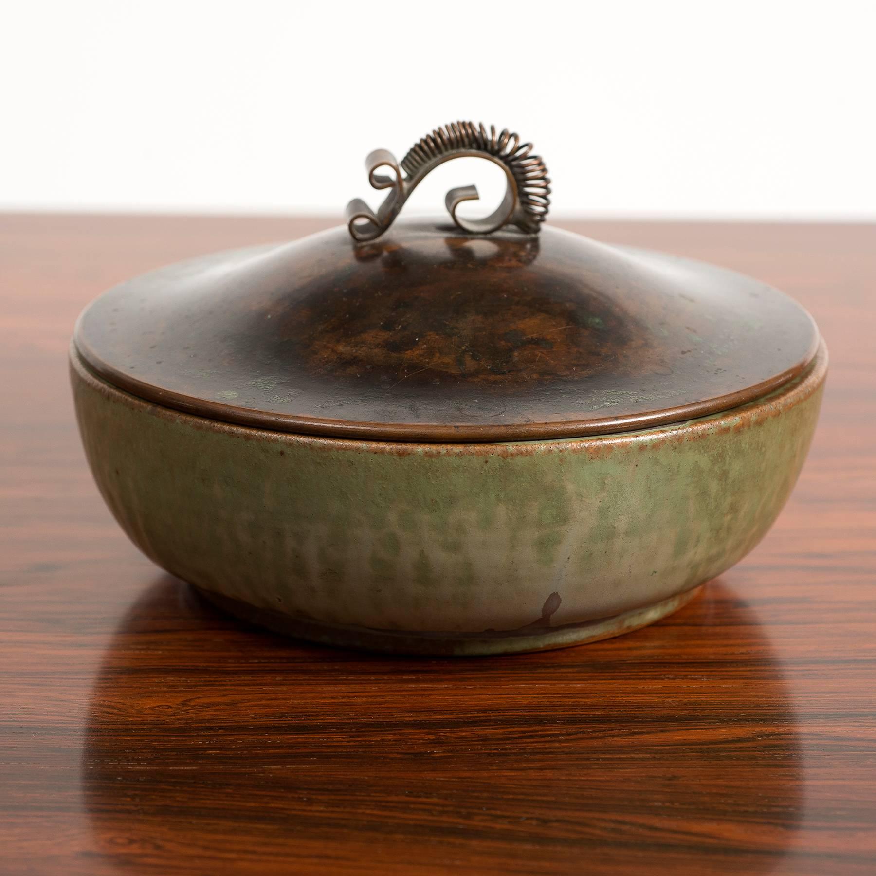 A stone bowl by Arne Bang decorated with green glaze and patinated bronze lid. Signed with monogram AB 183, Denmark, 1940s.