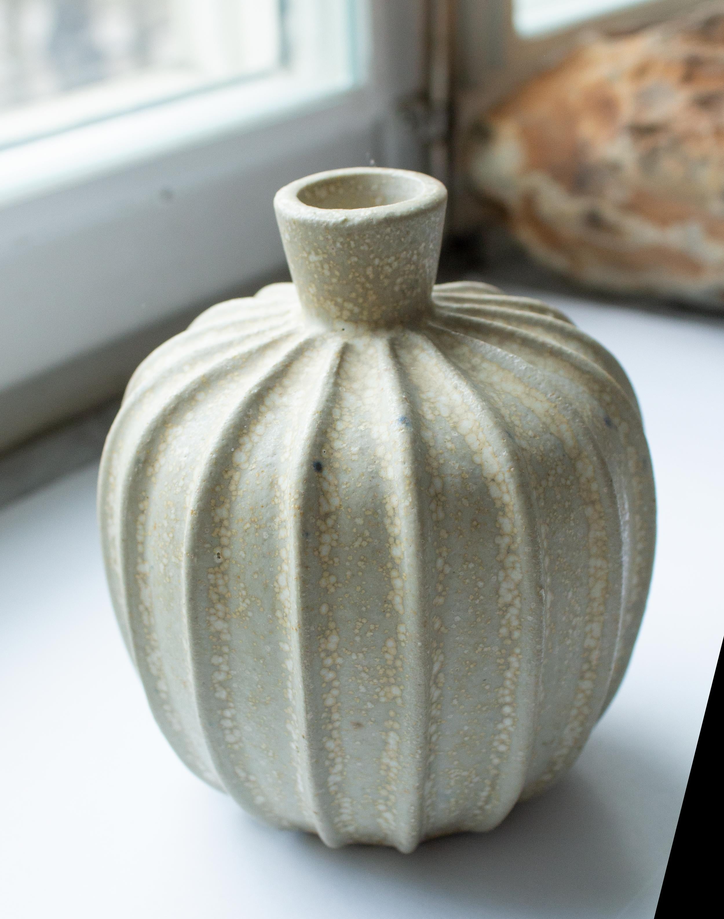 A rare Arne Bang (1901-1983, stoneware vase with ribbed corpus decorated with sand-colored eggshell glaze body. Signed with Bang’s monogram on the underside, No. 2. Perfect condition. Other designers of the same period includes Axel Salto, Wilhelm