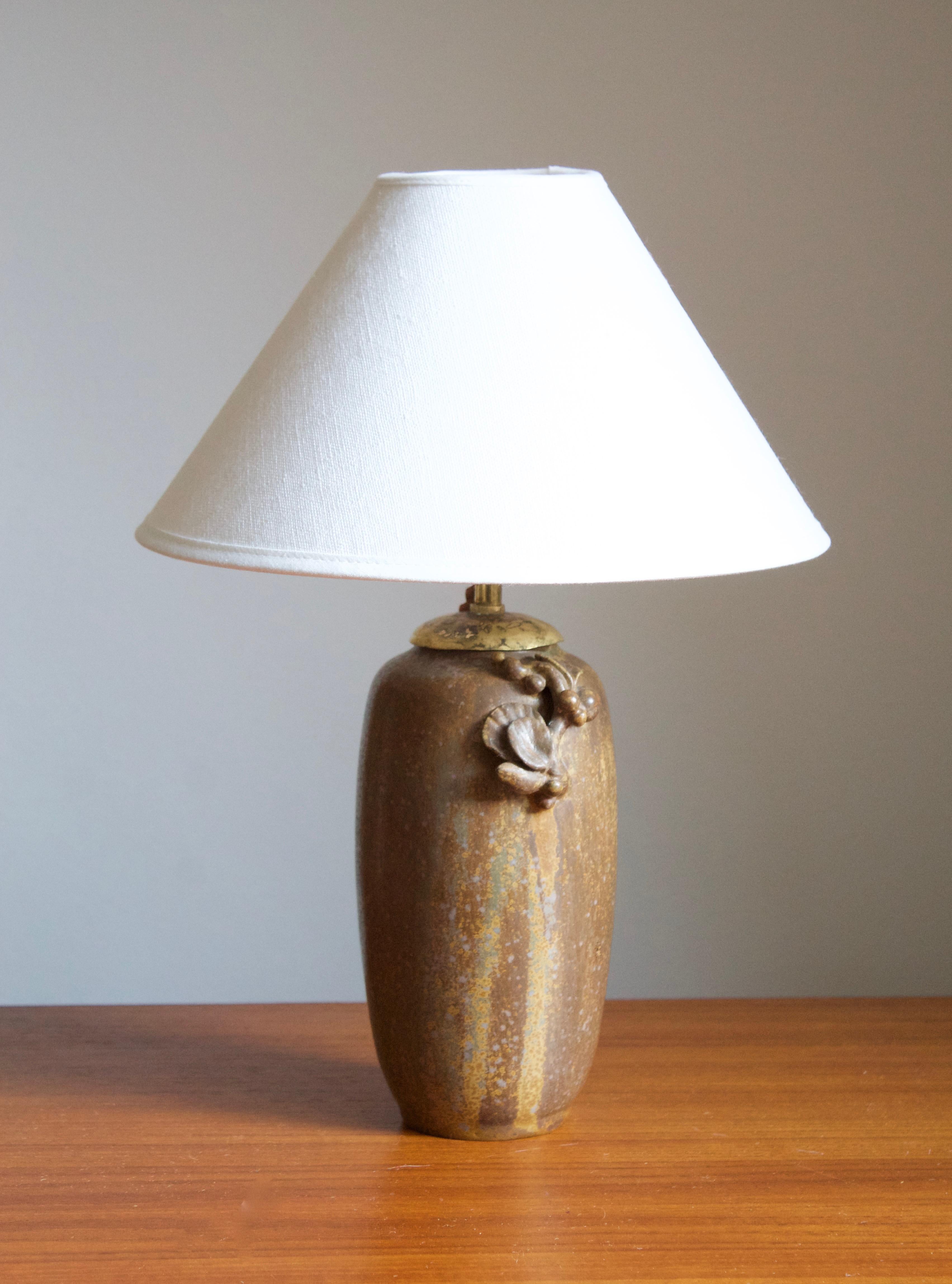 A table lamp. Designed by Arne Bang, produced, c. 1927. Glazed stoneware. Features ornamental floral motifs iconic to Bangs production.

Stated dimensions exclude the lampshade. Stated height includes socket. Sold without lampshade.

Other designers