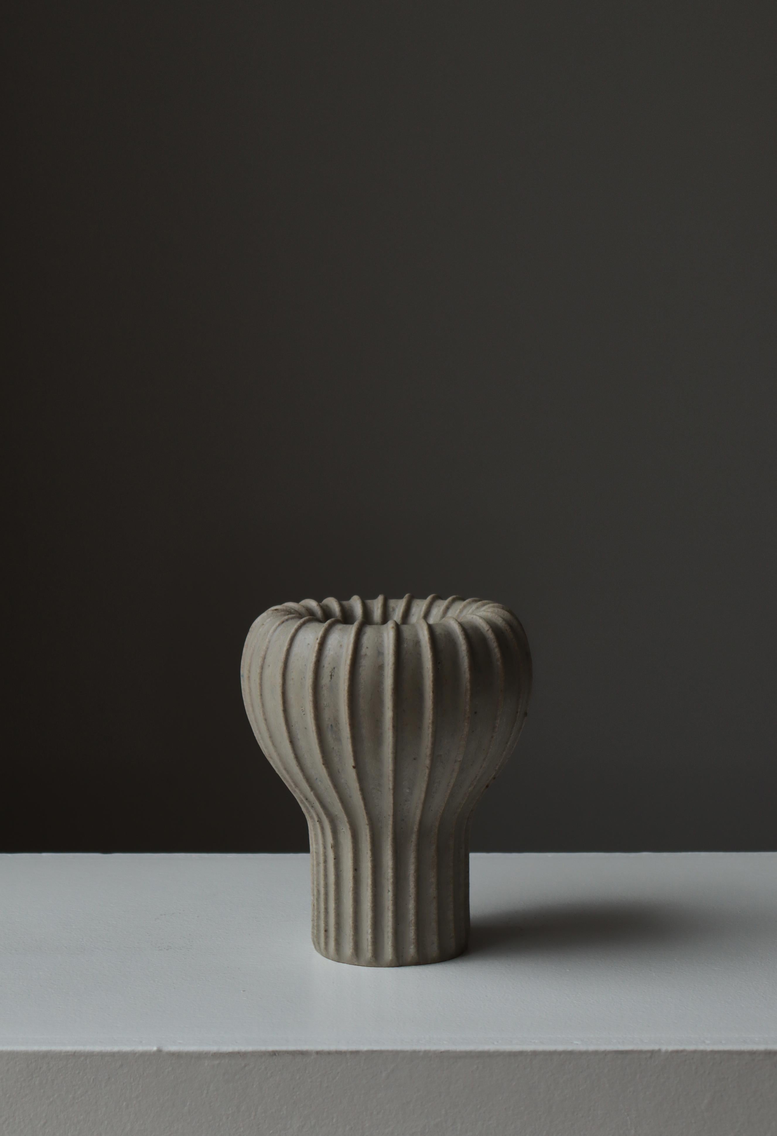 A sculptural Art Deco stoneware vase by Arne Bang, model 139, exemplifying the Danish master’s iconic organic modernism. This form—one of Bang’s most celebrated—features a dramatically fluted silhouette that swells into a bulbous upper section