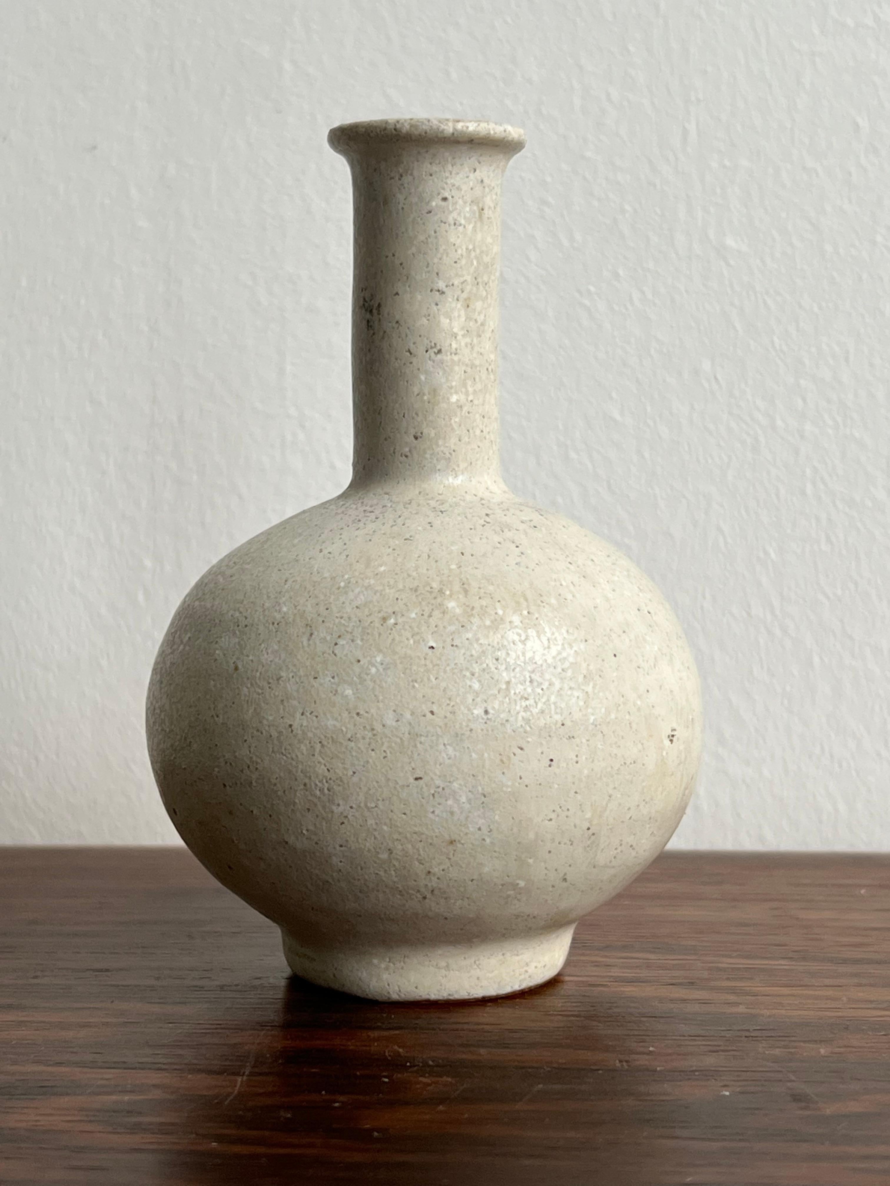 Arne Bang, a small vase from own studio, made in the 1930’s. It’s covered with a desirable white glaze and shaped as a bottle and signed AB in the bottom. Arne Bang was a very productive potter in the 1930’s, known for his very decorative shapes,
