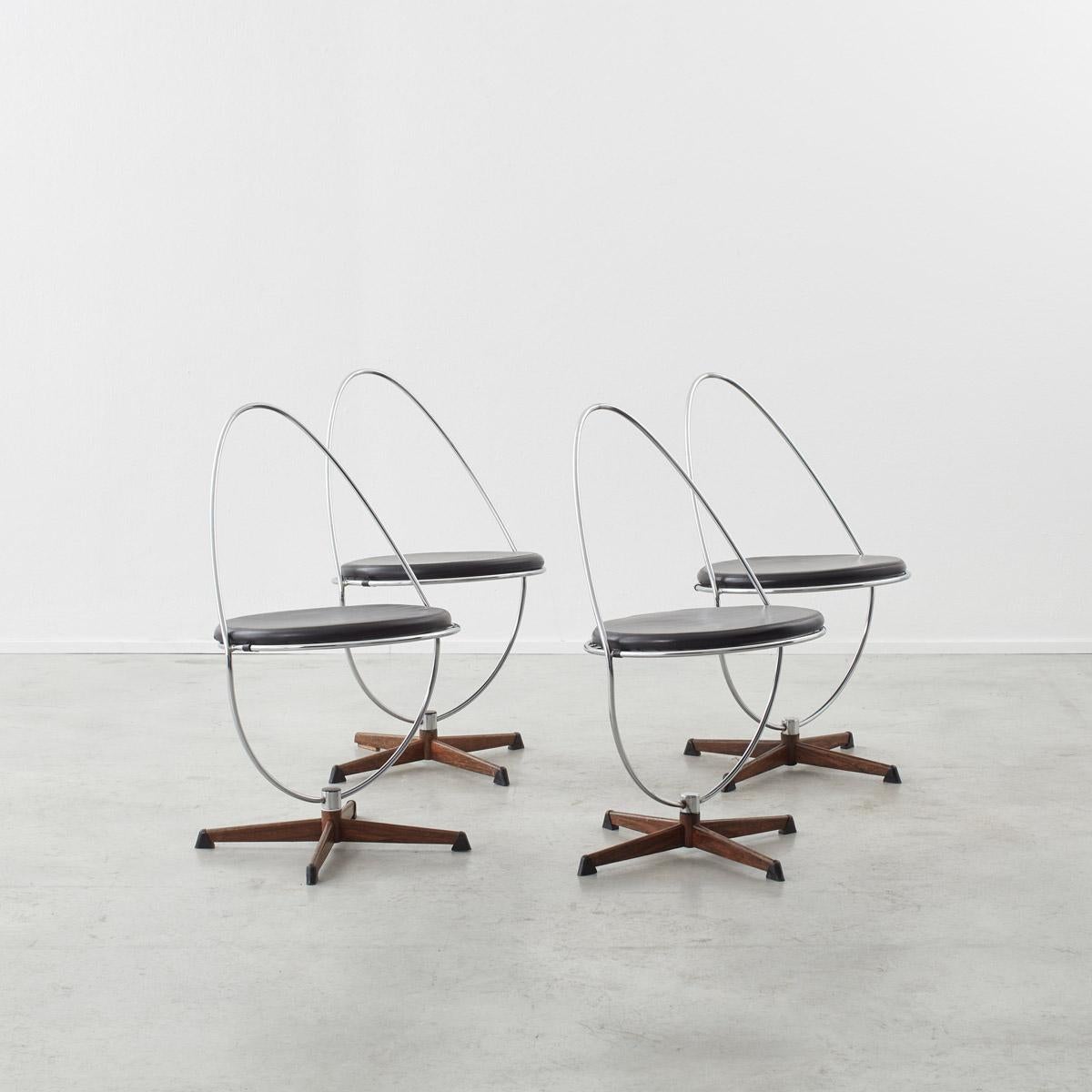 This set of four Arne Dahle`n chairs was manufactured by Dahléns Company in the Swedish town Dalum. His company was solely devoted to the production of chairs often which featured high pointed backs. This set of dining chairs reimagines this