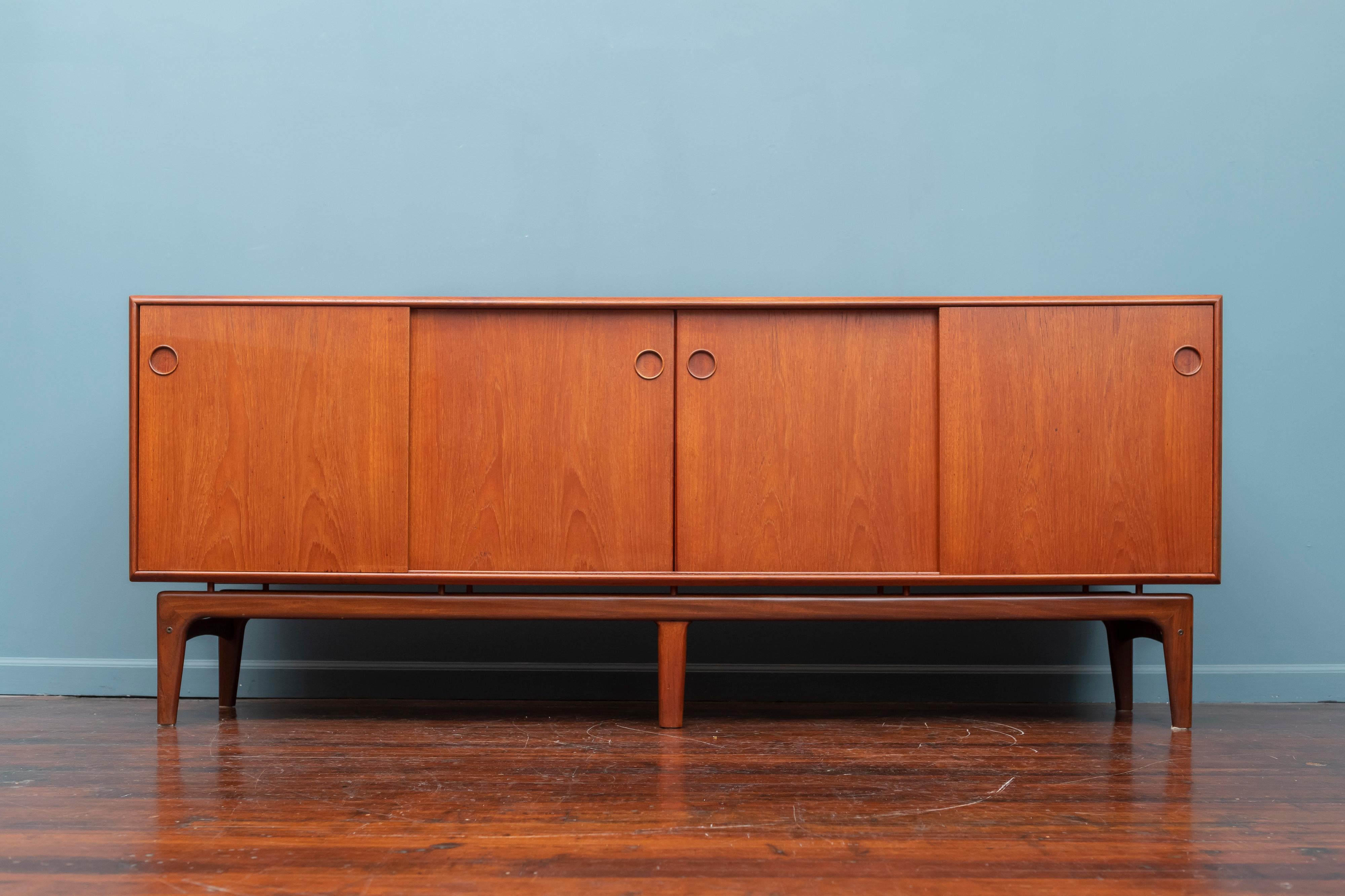 Arne Hovmand Olsen design teak credenza with superb attention to details and quality. Featuring a bank of five drawers, two separate storage compartments with adjustable shelves on floating base. Newly refinished.