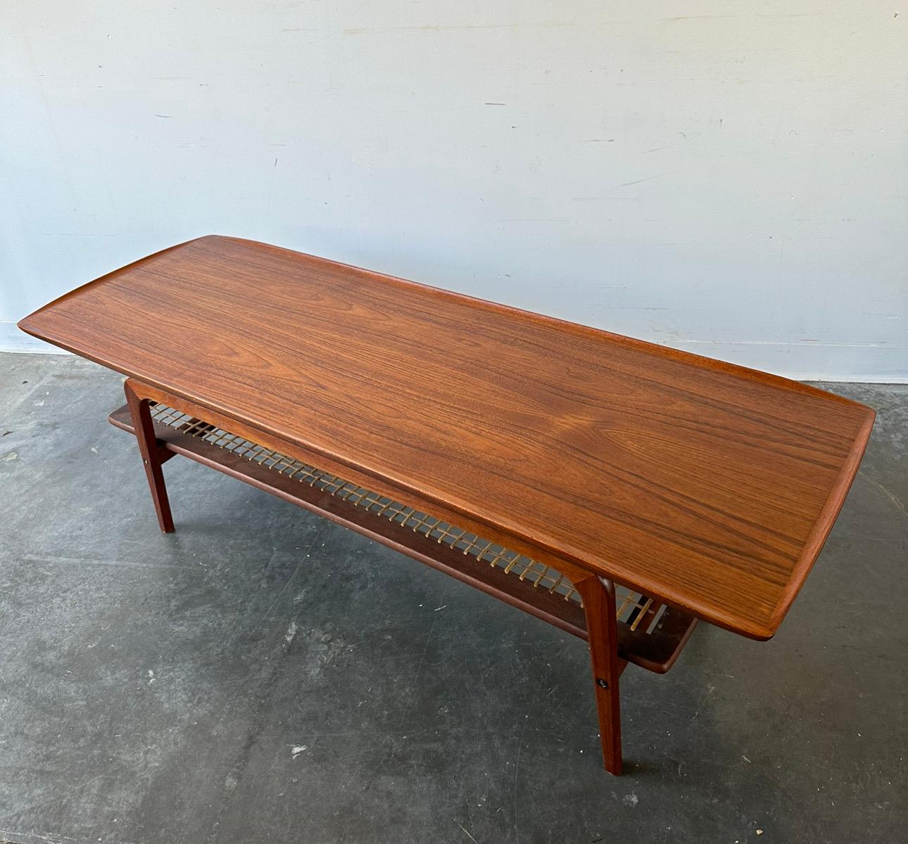 Arne Hovmand-Olsen Mid-Century Modern Coffee Table

Outstanding danish teak surfboard style coffee table with original cane shelf. The piece has been restored minus the shelf which is original, the cane has some
Light breaking at the edges.


