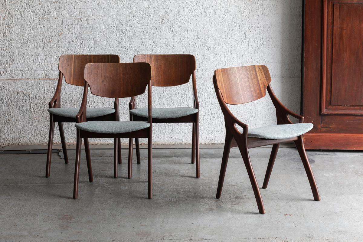 Set of 4 dining chairs designed by Arne Hovmand Olsen and produced by Mogens Kold in Denmark in the 1960s. Made of solid teak and teak veneer with a greyish blue seating. Newly upholstered in our atelier. In good condition as shown in the