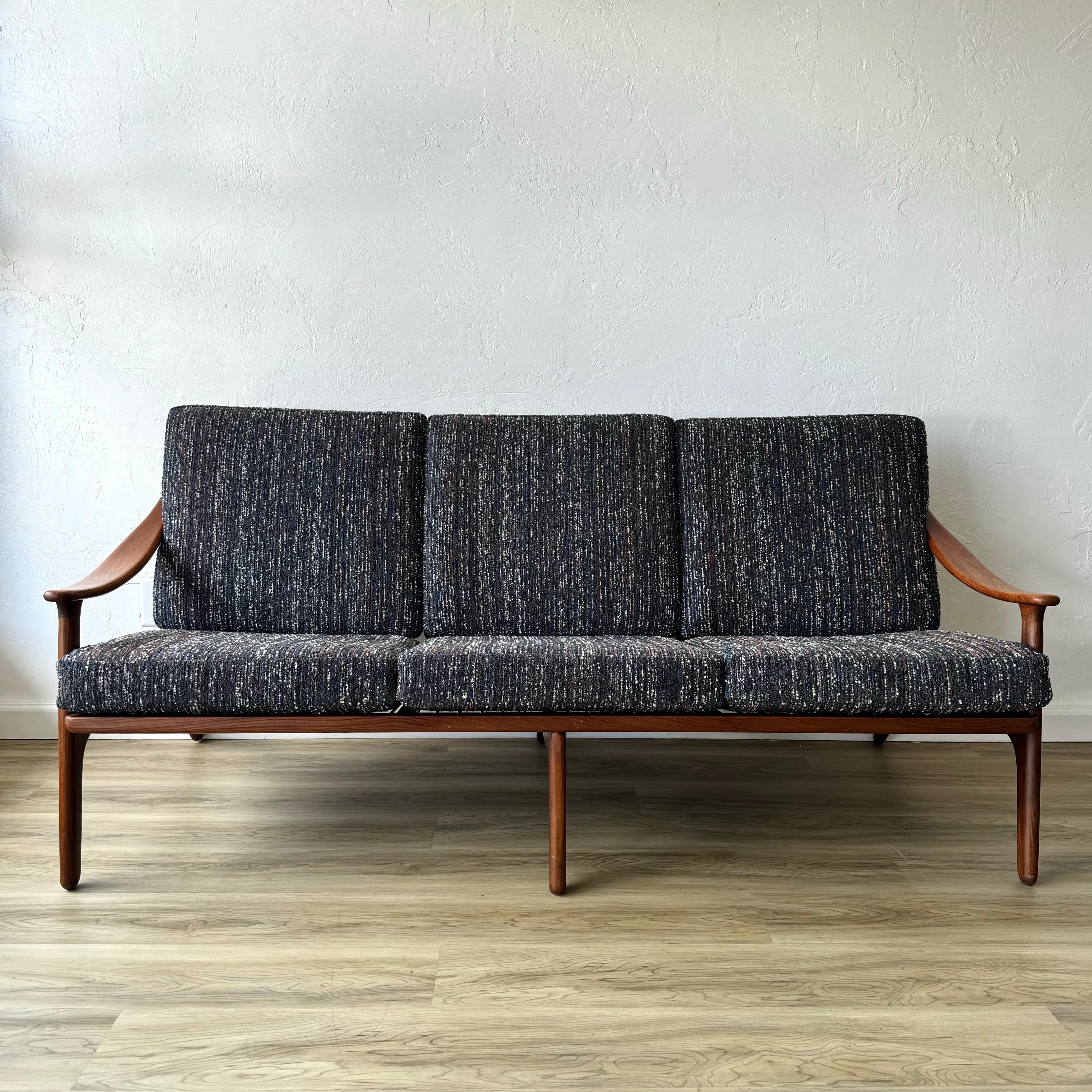 A finely restored sculptural teak sofa by designer Arne Hovmand Olsen for Komfort. Made in Denmark in the late 50s or early 60s. It has been fully cleaned, oiled and new cushions made with a period correct, textural fabric. 

