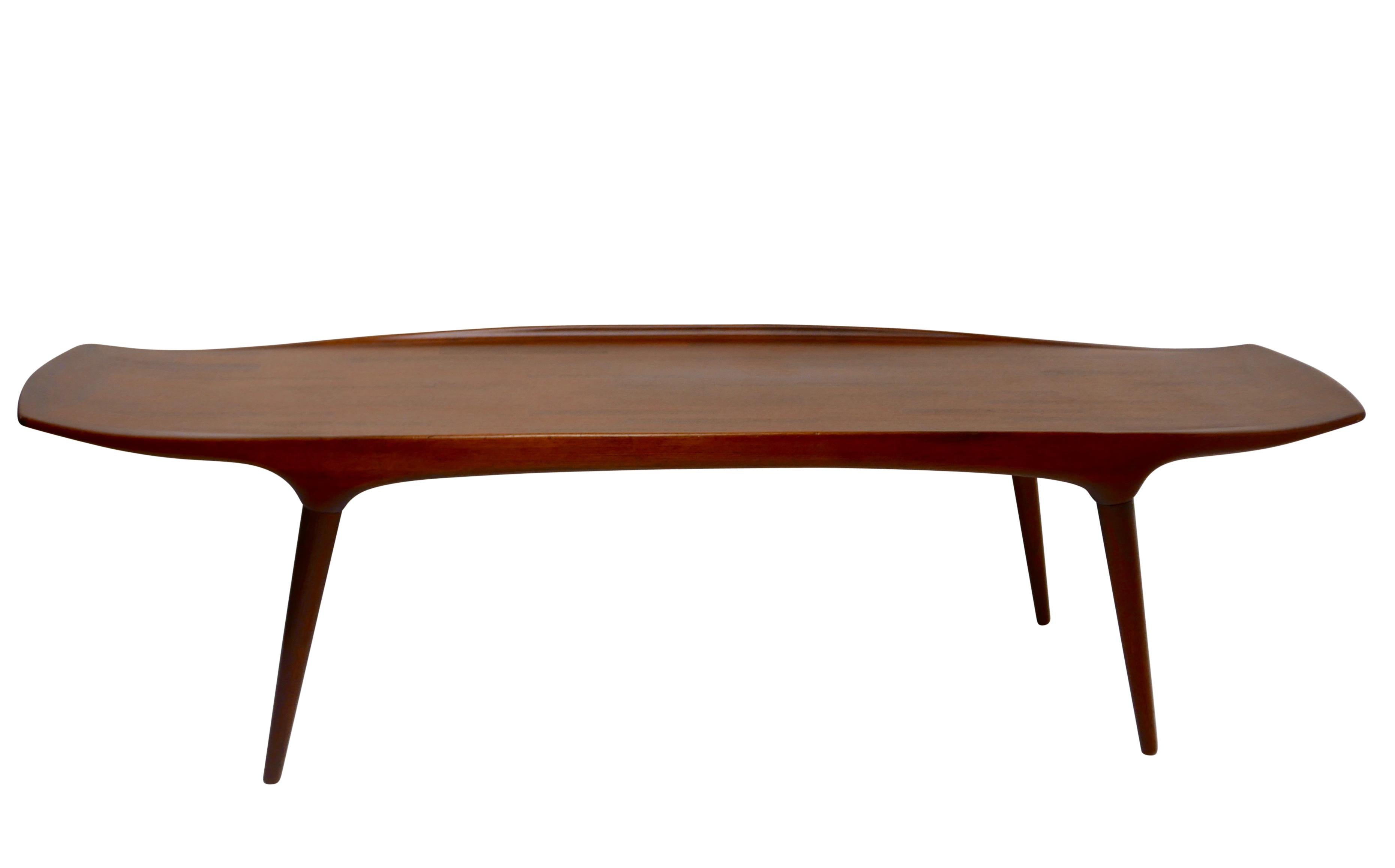 A long sleek teak wood coffee table with four tapering cylindrical legs. Having it's original metal label on the underside, Craftsmanship - Made in Denmark - MK.
Arne Hovmand Olsen for Mogens Kold
1960s.