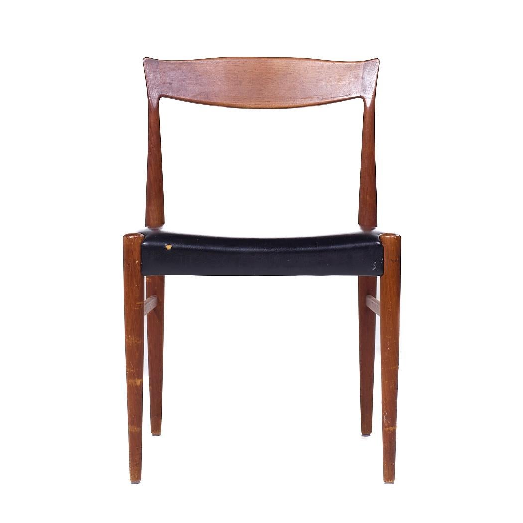 Arne Hovmand Olsen Mid Century Danish Teak Dining Chair

This chair measures: 19.75 wide x 19 deep x 31.5 inches high, with a seat height/chair clearance of 18 inches

We take our photos in a controlled lighting studio to show as much detail as