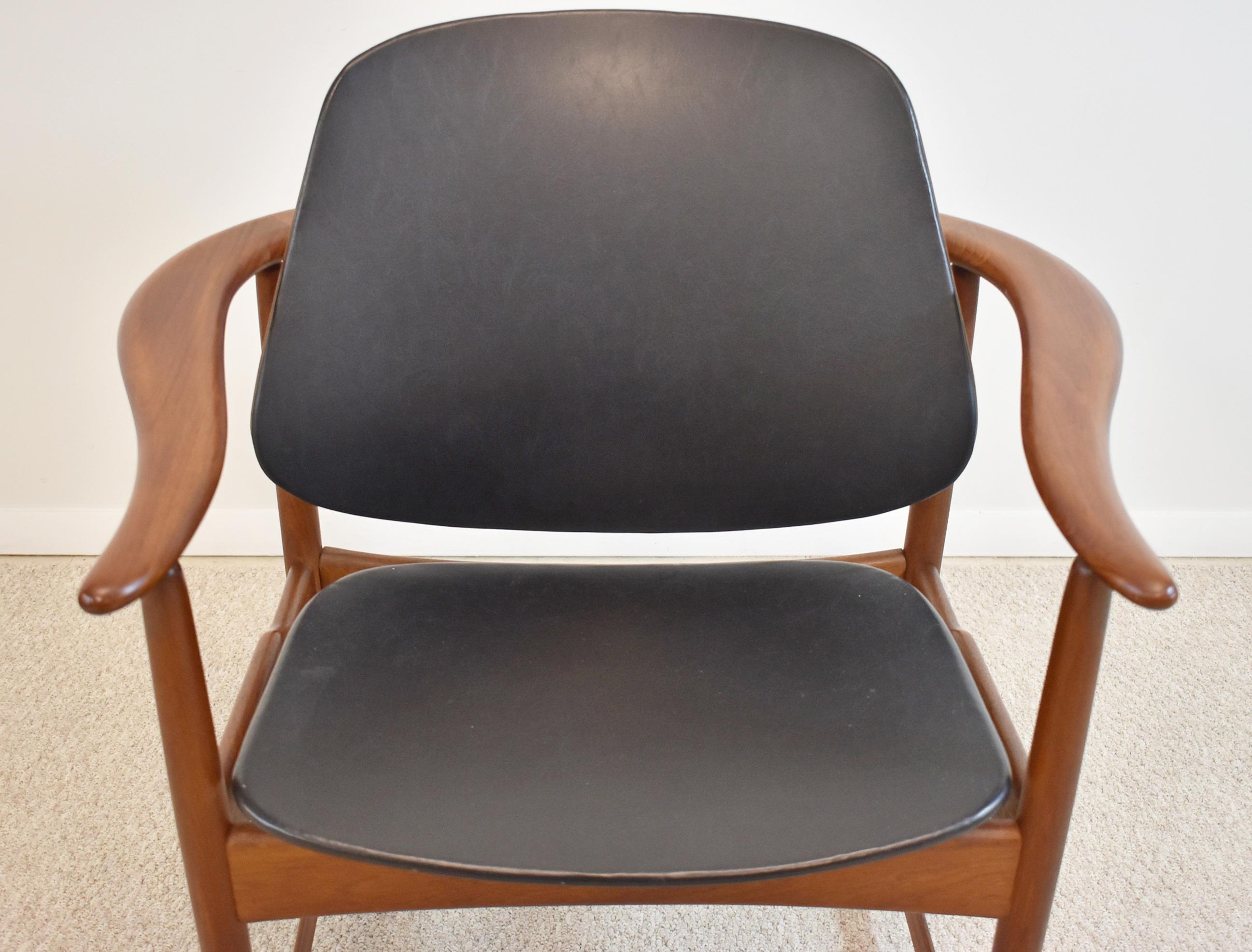 Mid-Century Modern danish teak armchair by Arne Hovmand-Olsen, circa 1960s. Mid-century modern chair in solid teak with floating back. Armrest is made in one piece in a horseshoe form around the back of the chair. Great design of brass tube